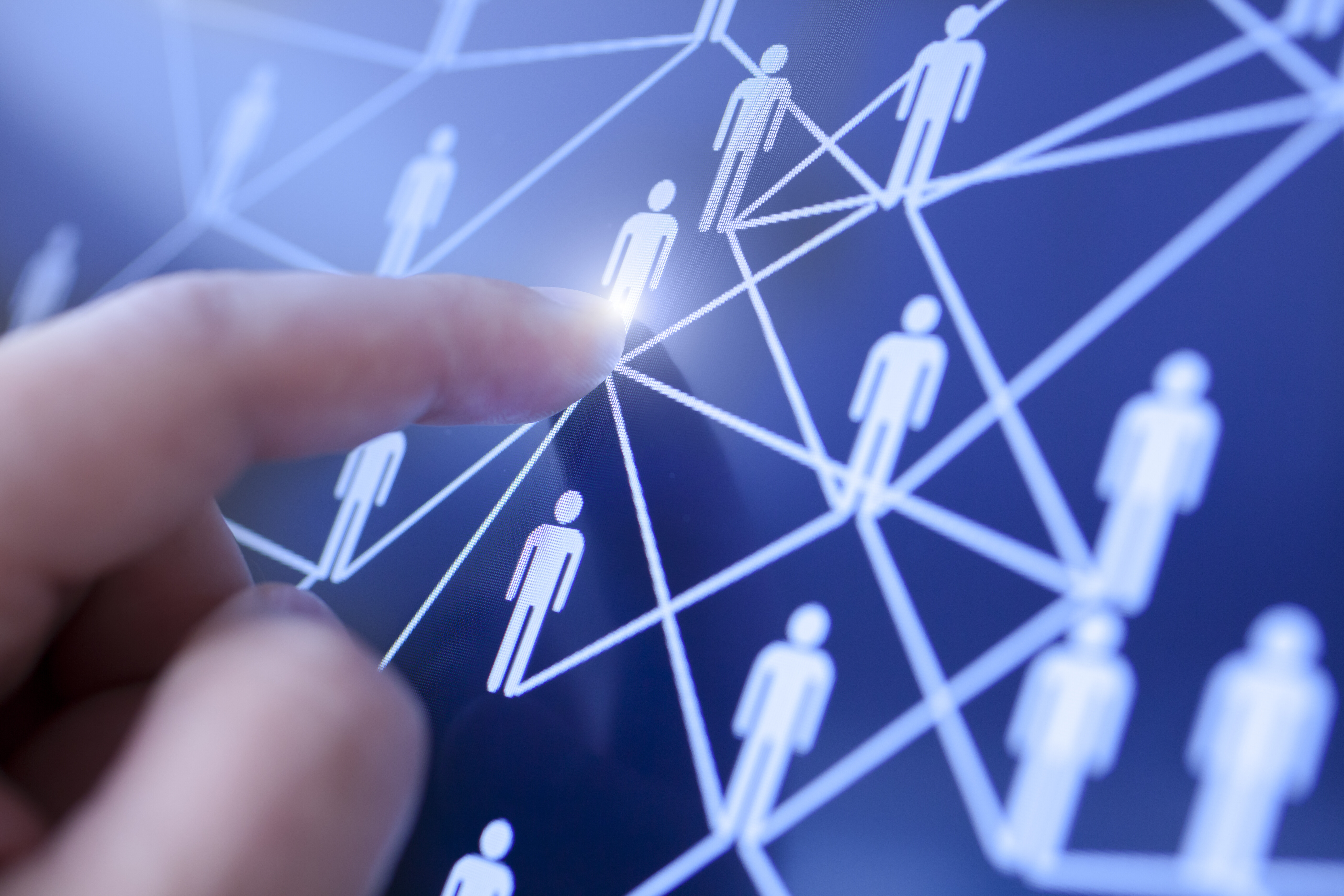 Human hand touching touchscreen with people networked together: Chief people officers should prioritize business acumen in staff as it enhances individual performance