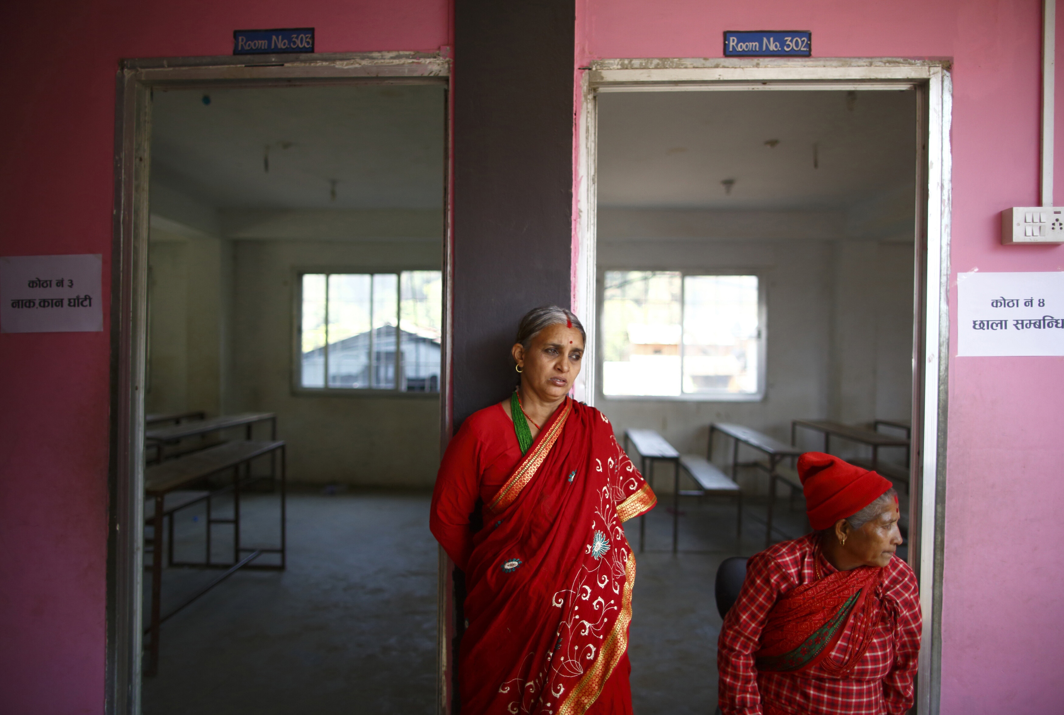 A woman waits outside a room as she waits to receive a free medical check-up during an event organized by the Amnesty International in Nuwakot around 60 km (37 miles) from Kathmandu March 6, 2014. The event titled "My Body My Rights" was launched to mark the beginning of the two-year campaign to raise awareness about gender discrimination and uterine prolapse in Nepal: Women’s health is having a moment of momentum