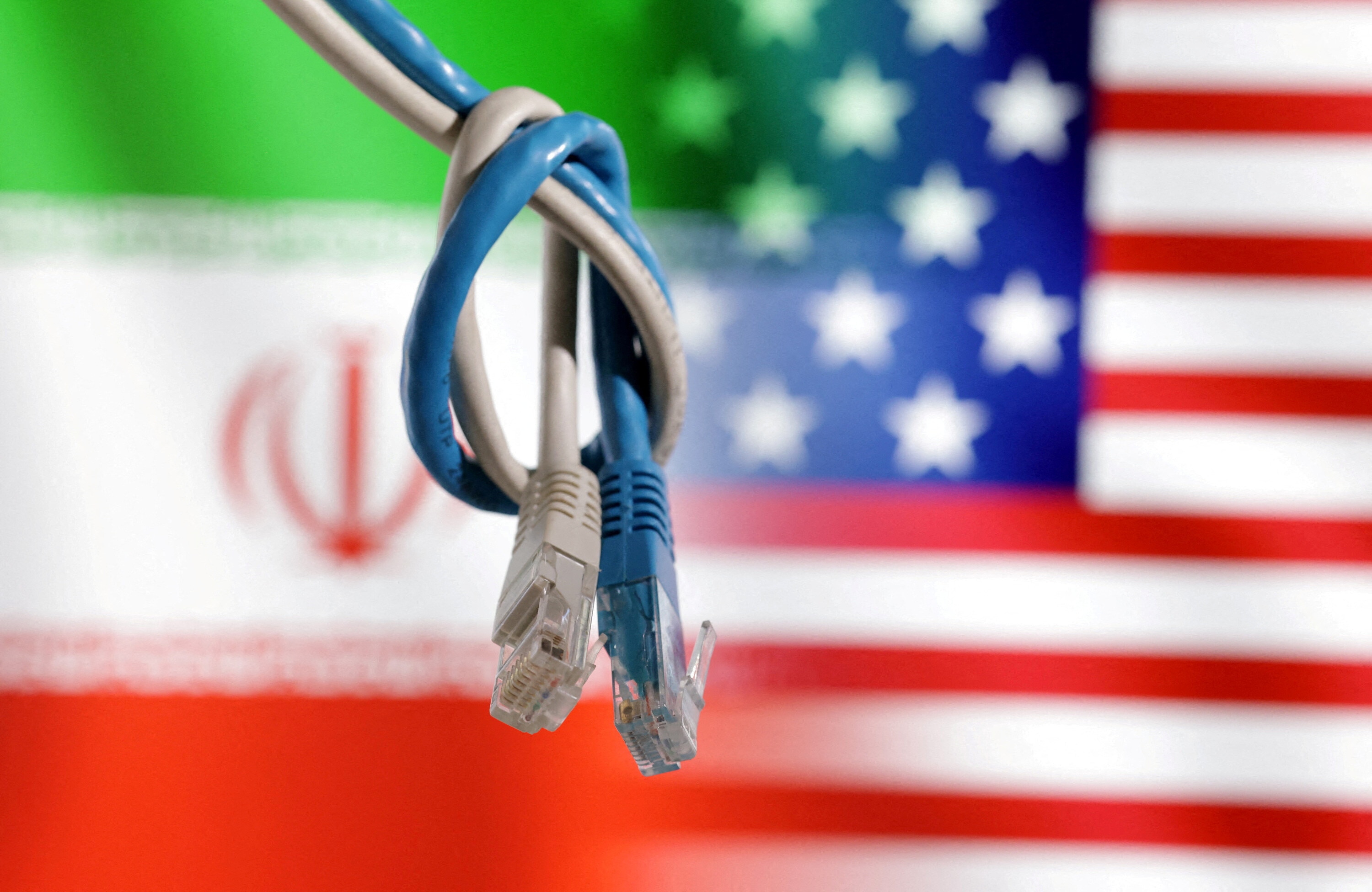 LAN cables are seen in front of U.S. and Iran flags in this illustration.