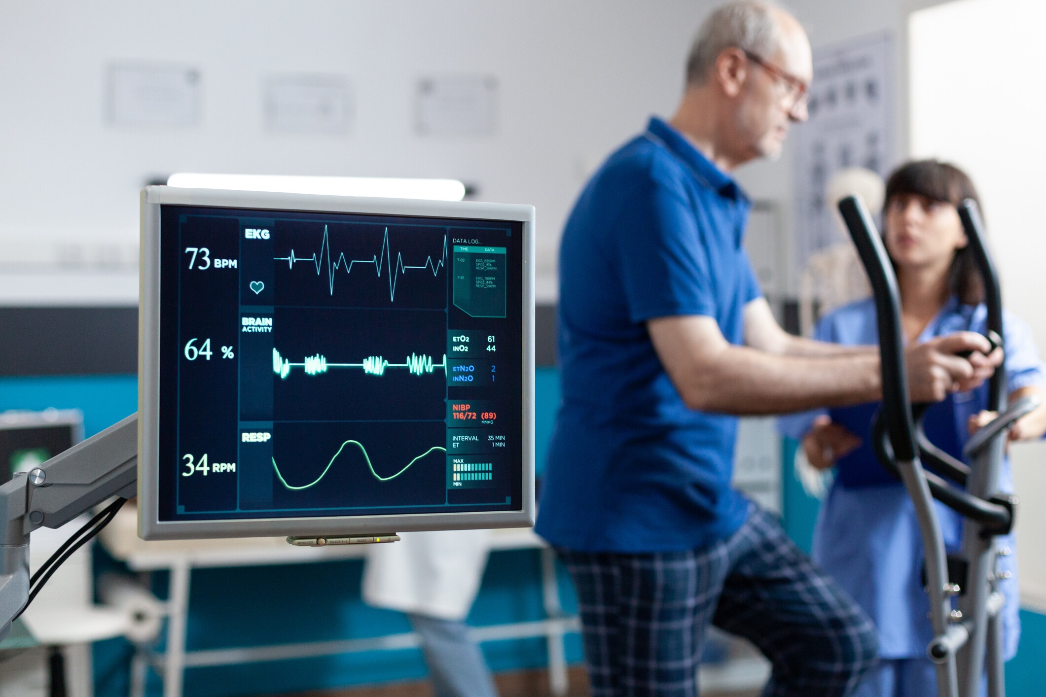 Close up of heart rate monitor measuring heartbeat for patient doing gymnastics for physical recovery. Man using sport equipment to exercise for physiotherapy and strength. Chronic disease.