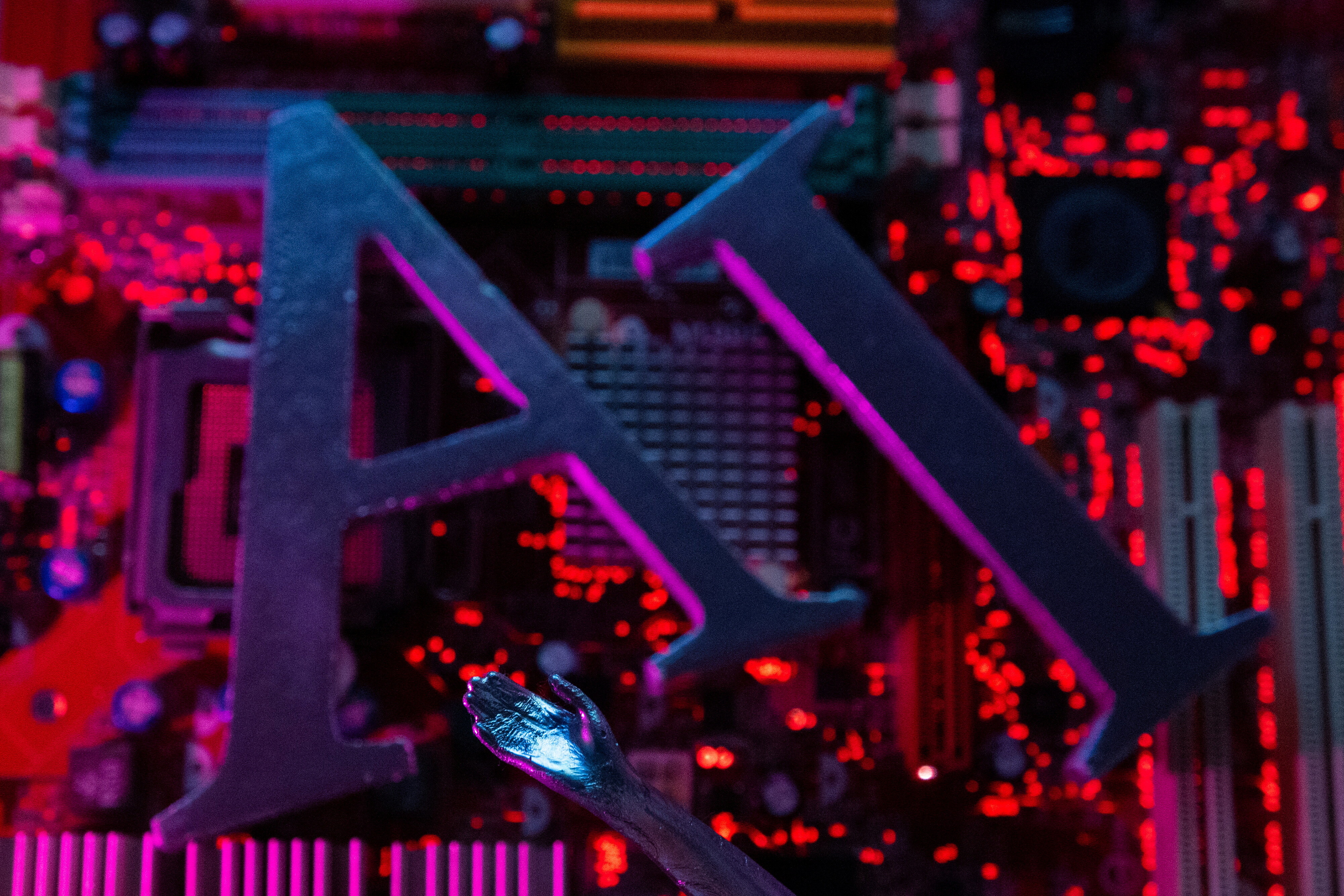 AI (Artificial Intelligence) letters and robot hand are placed on computer motherboard in this illustration taken, June 23, 2023: Automation is driving AI overcapacity in traditional roles where AI-critical skills are still lacking for post holders