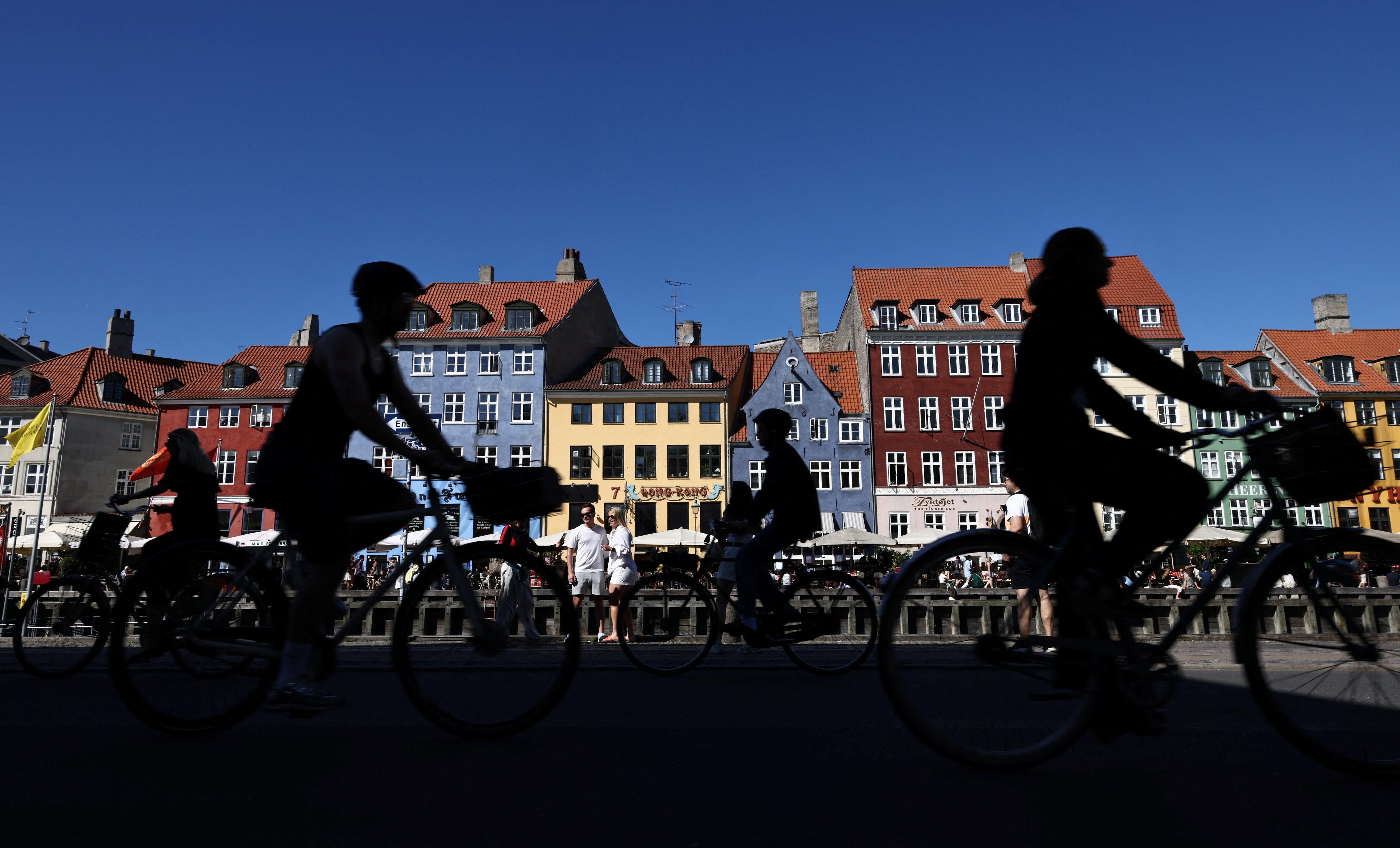 Cyclists ride past the Nyhavn area of Copenhagen, Denmark, June 23, 2026. REUTERS/Tom Little
