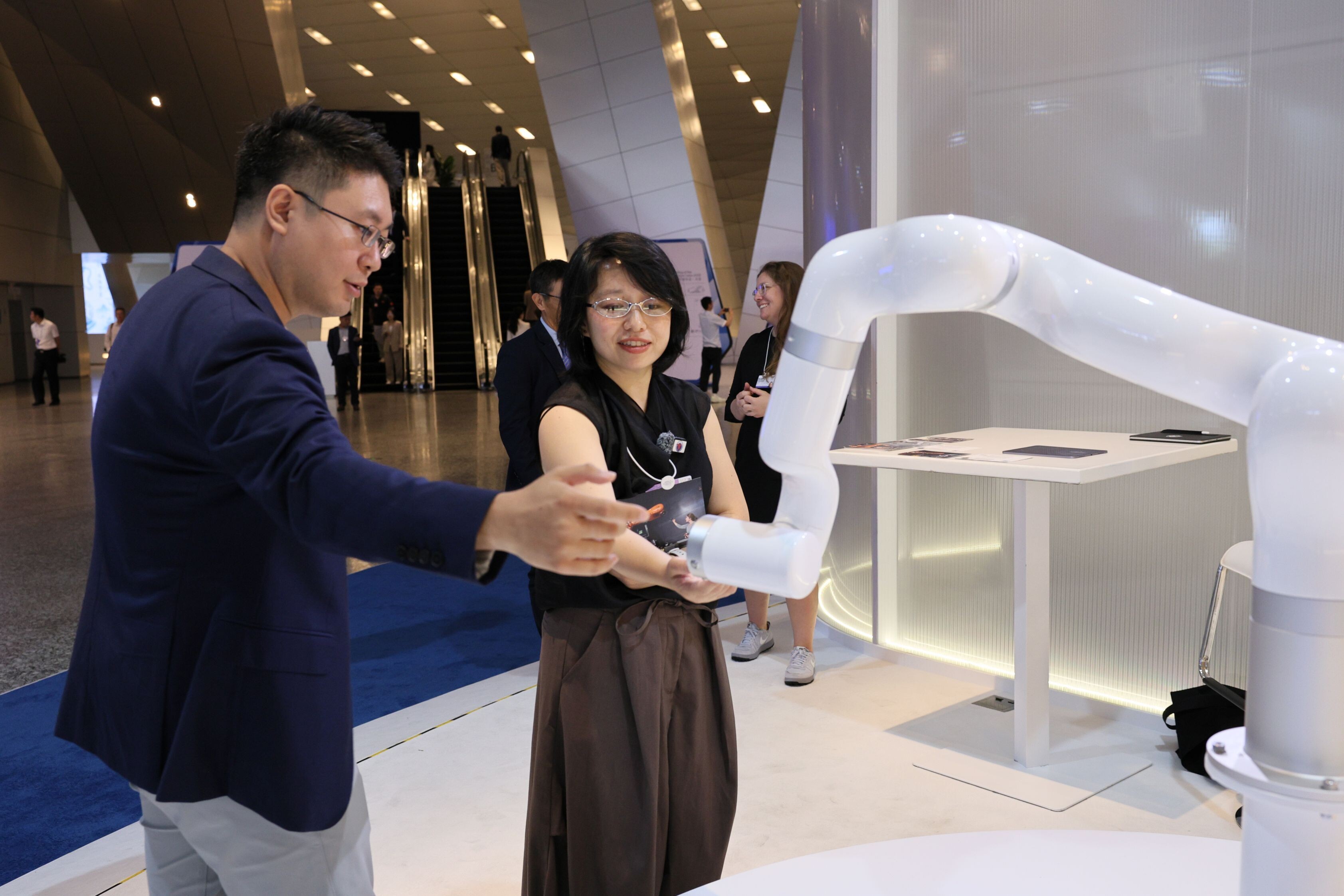 Visitors to the Annual Meeting of the New Champions 2026 interact with Madeleine Gannon's exhibit