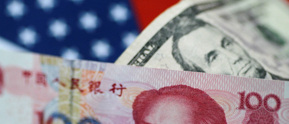 U.S. Dollar and China Yuan notes are seen in this picture illustration June 2, 2017. REUTERS/Thomas White/Illustration - RC1E290C4B00