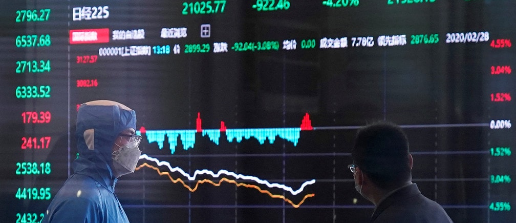 A worker wearing a protective suit is seen inside the Shanghai Stock Exchange building, as the country is hit by a new coronavirus outbreak, at the Pudong financial district in Shanghai, China February 28, 2020. REUTERS/Aly Song - RC2L9F9IFTQ0