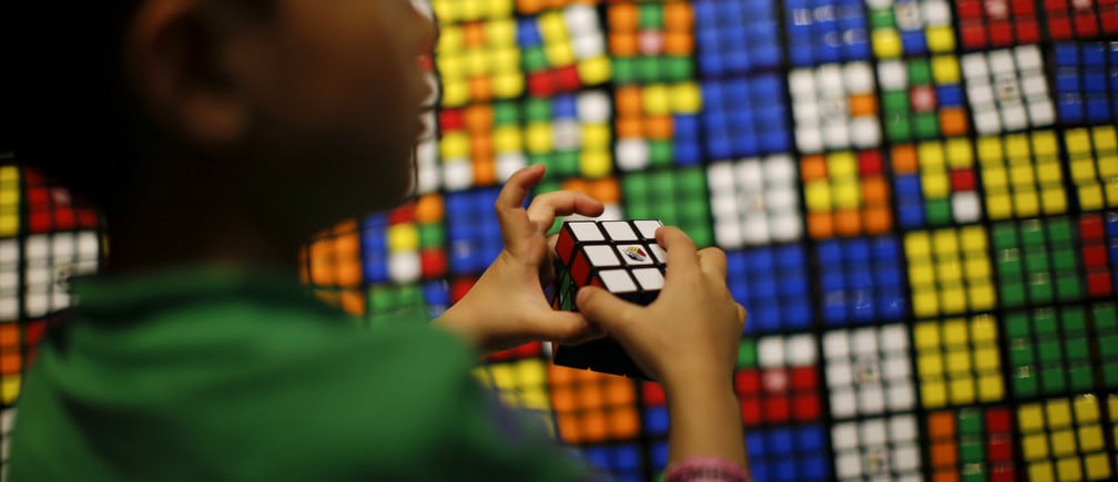 A boy plays with the Rubik's cube during an event to mark the 40th anniversary of the puzzle toy at the Liberty Science Center in Jersey City, New Jersey, April 26, 2014. REUTERS/Eduardo Munoz (UNITED STATES - Tags: SOCIETY ANNIVERSARY) - GM1EA4R0B2Z01