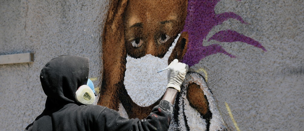 Serigne Boye aka Zeus, a graffiti artist from RBS crew works on his mural to encourage people to protect themselves amid the outbreak of the coronavirus disease (COVID-19), in Dakar, Senegal March 25, 2020. Picture taken March 25, 2020. REUTERS/Zohra Bensemra - RC2BSF9EKZX1