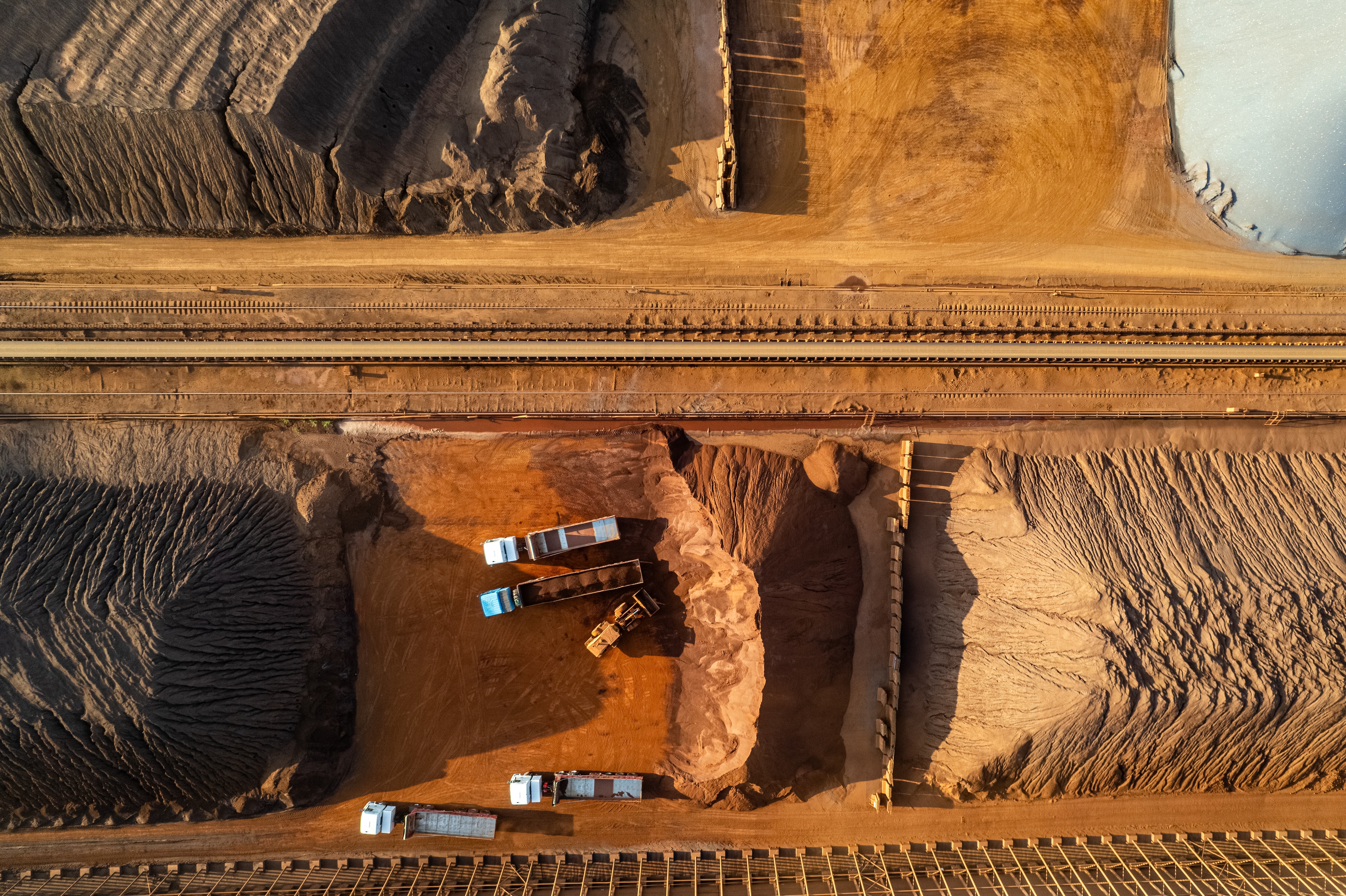 Aerial view of engineering vehicles working in non-ferrous metal mines.