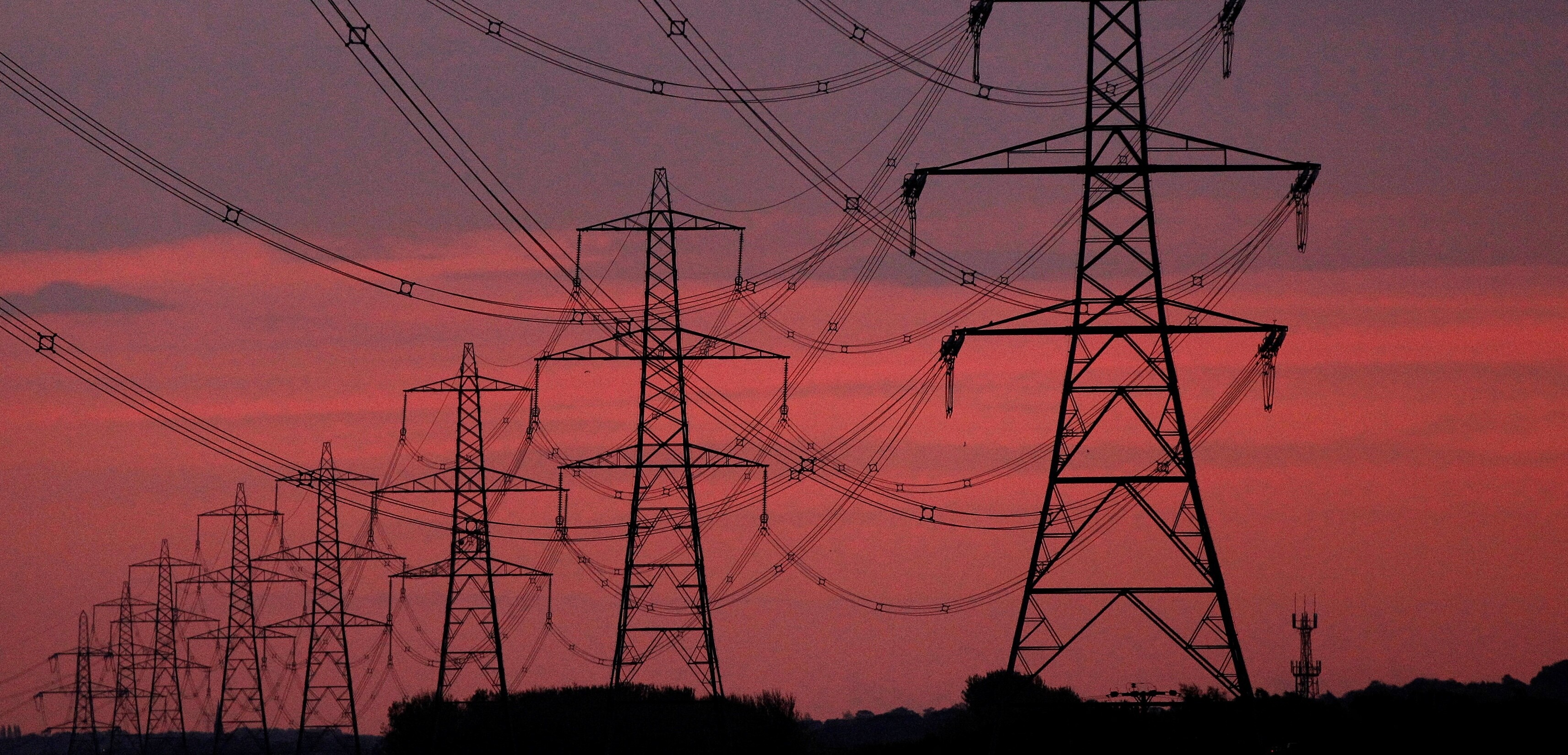 The sun rises behind electricity pylons near Chester, northern England, October 24, 2011. 