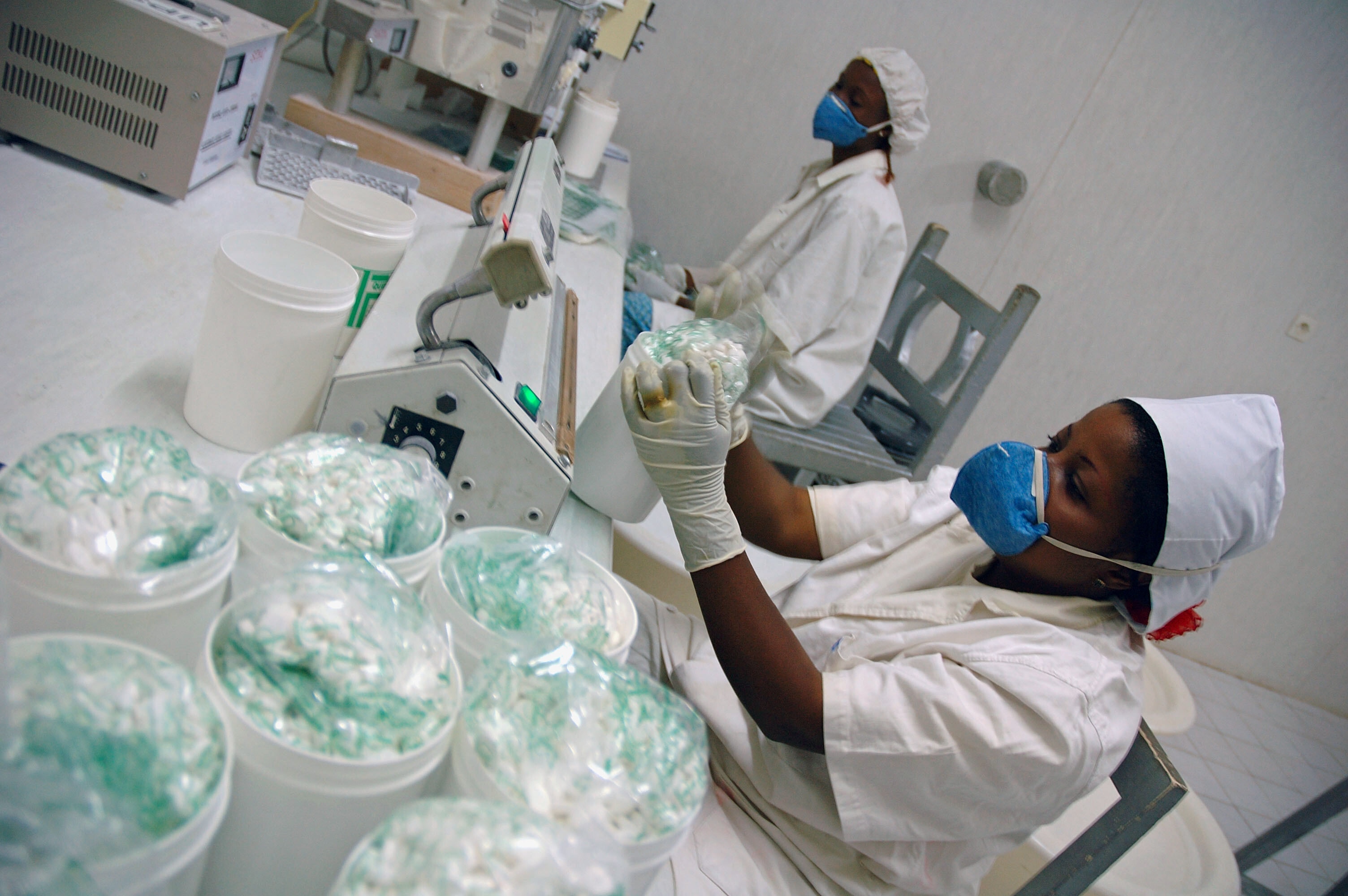 Pharmacists make quinine tablets at a factory close to the shores of Lake Kivu in Bakavu, eastern Democratic Republic of Congo (DRC), August 3, 2006. Malaria is the biggest killer in the DRC, which is also the world's largest producer of the cinchona bark used to make quinine:  The African pharmaceutical market is projected to exceed $50 billion by 2030
