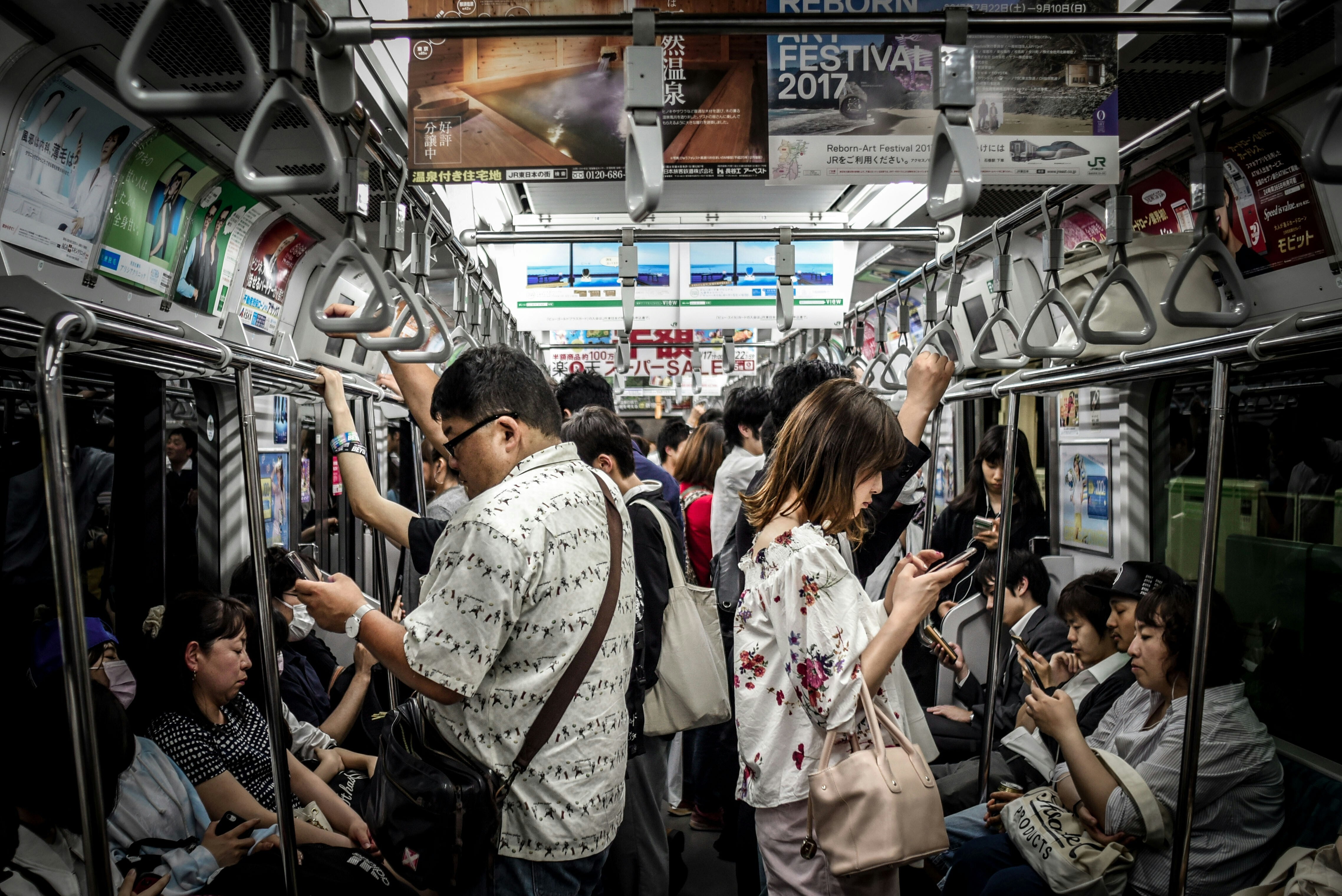 People on phone in busy metro train: Nonprofits quietly underpin global cyber resilience