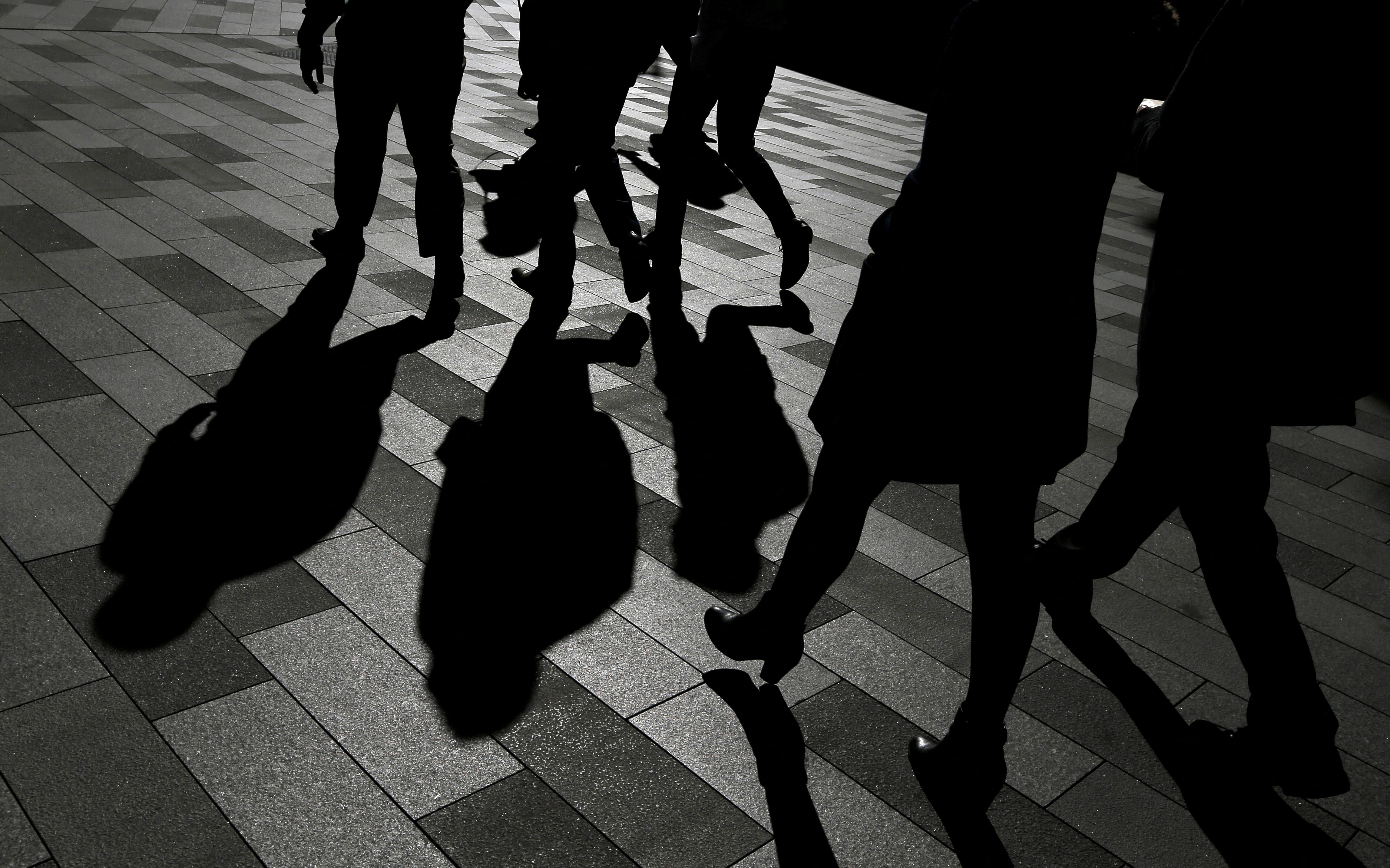 FILE PHOTO: Workers cast shadows as they stroll among the office towers Sydney's Barangaroo business district in Australia's largest city, May 8, 2017.  REUTERS/Jason Reed/File Photo