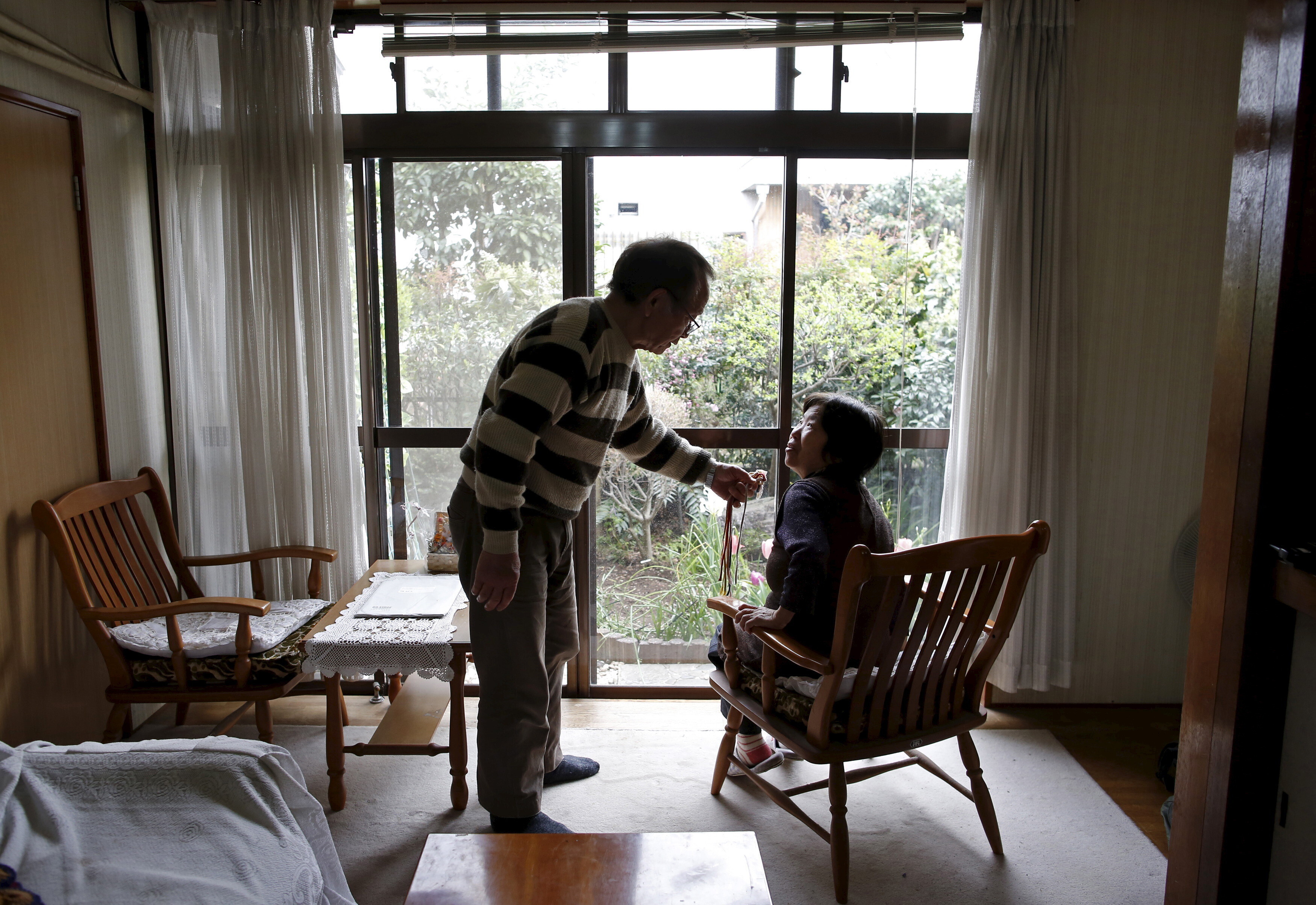 72-year-old Kanemasa Ito (L) and his 68-year-old wife Kimiko who was diagnosed with dementia 11 years ago, chat at their home in Kawasaki, south of Tokyo, Japan.