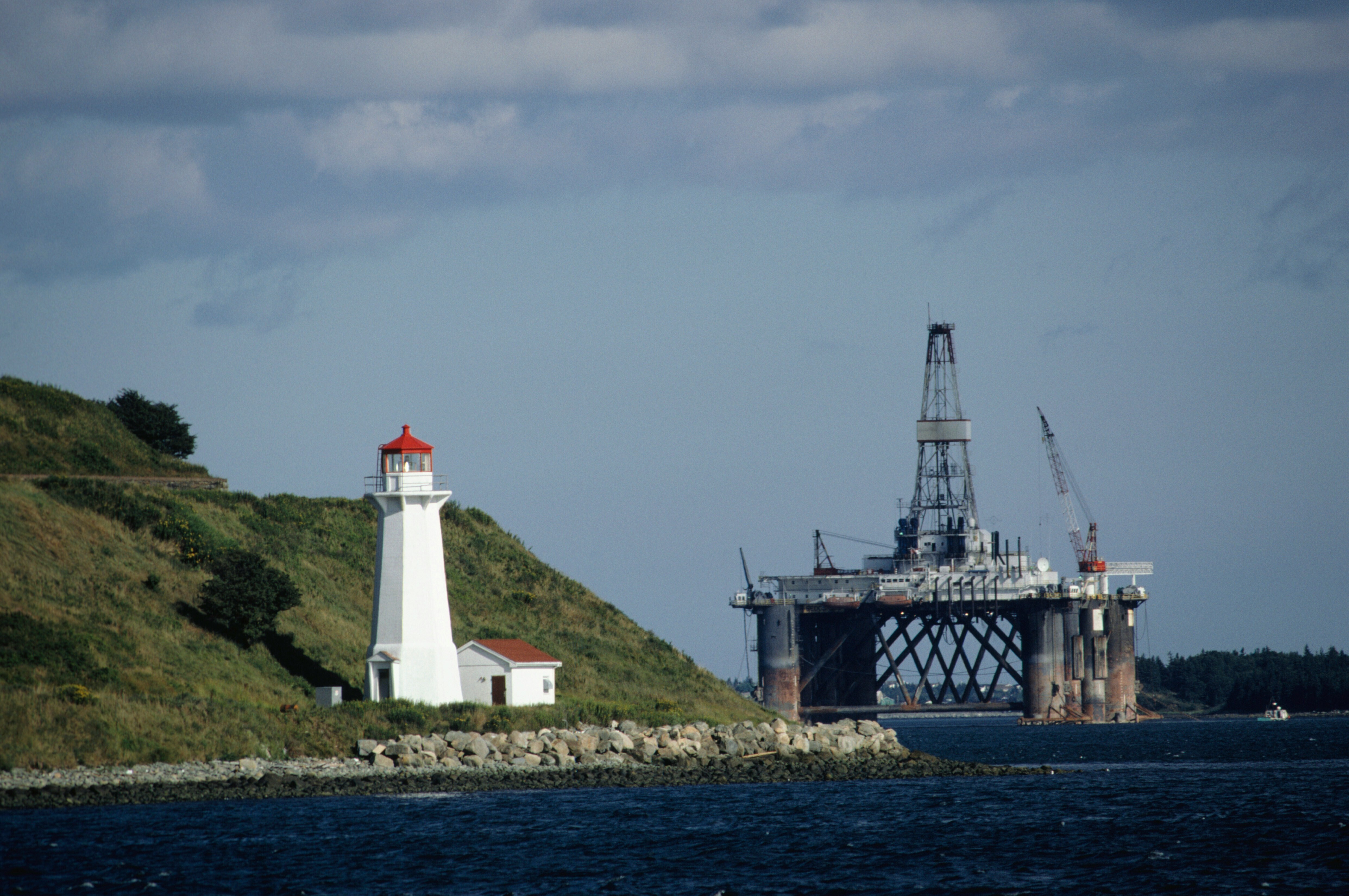 Lighthouse with oil rig in distance: The repurposing of industrial sites in the North Sea could provide a model worldwide