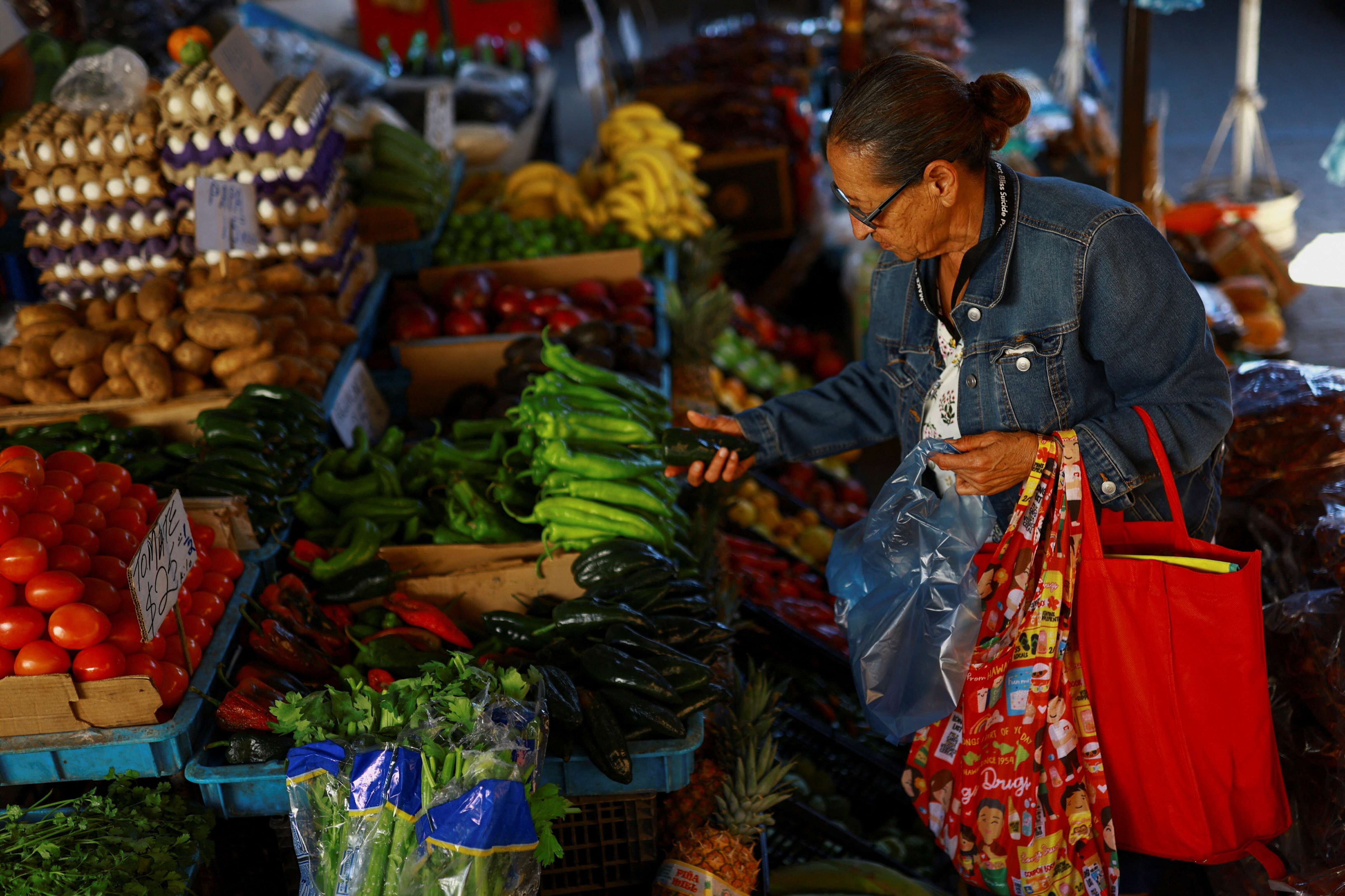 A woman buys vegetables at a market following March's inflation surge driven by rising food and energy prices, in Ciudad Juarez, Mexico, 15 April, 2026.
