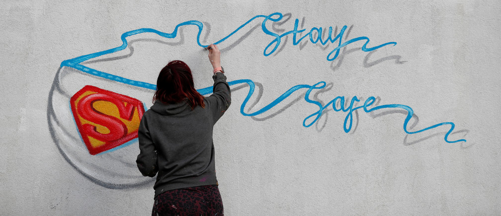 Artist Rachel List paints a mural, as the spread of the coronavirus disease (COVID-19) continues, in Pontefract, Britain, April 6, 2020. REUTERS/Lee Smith     TPX IMAGES OF THE DAY - RC2WYF9SJJ37