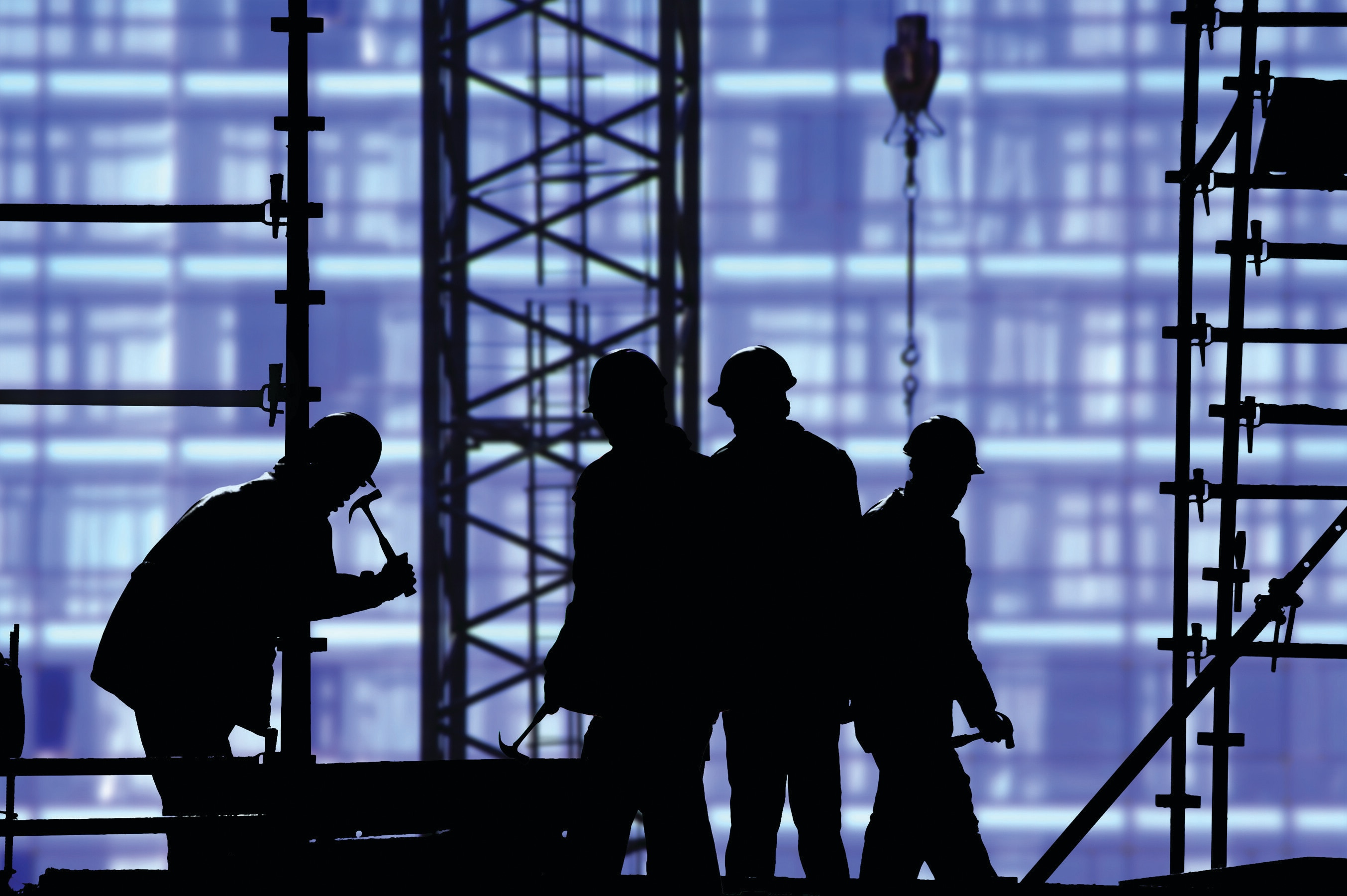 Labour: Workers with hard hats on a construction site.