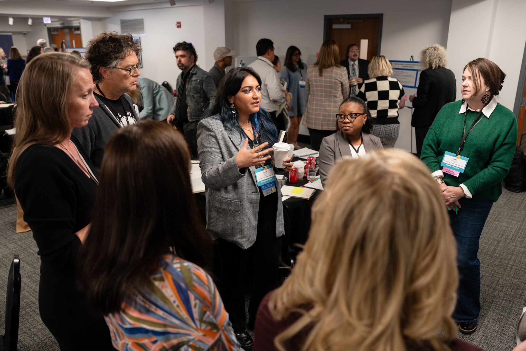 A group of people talk together at a conference.
