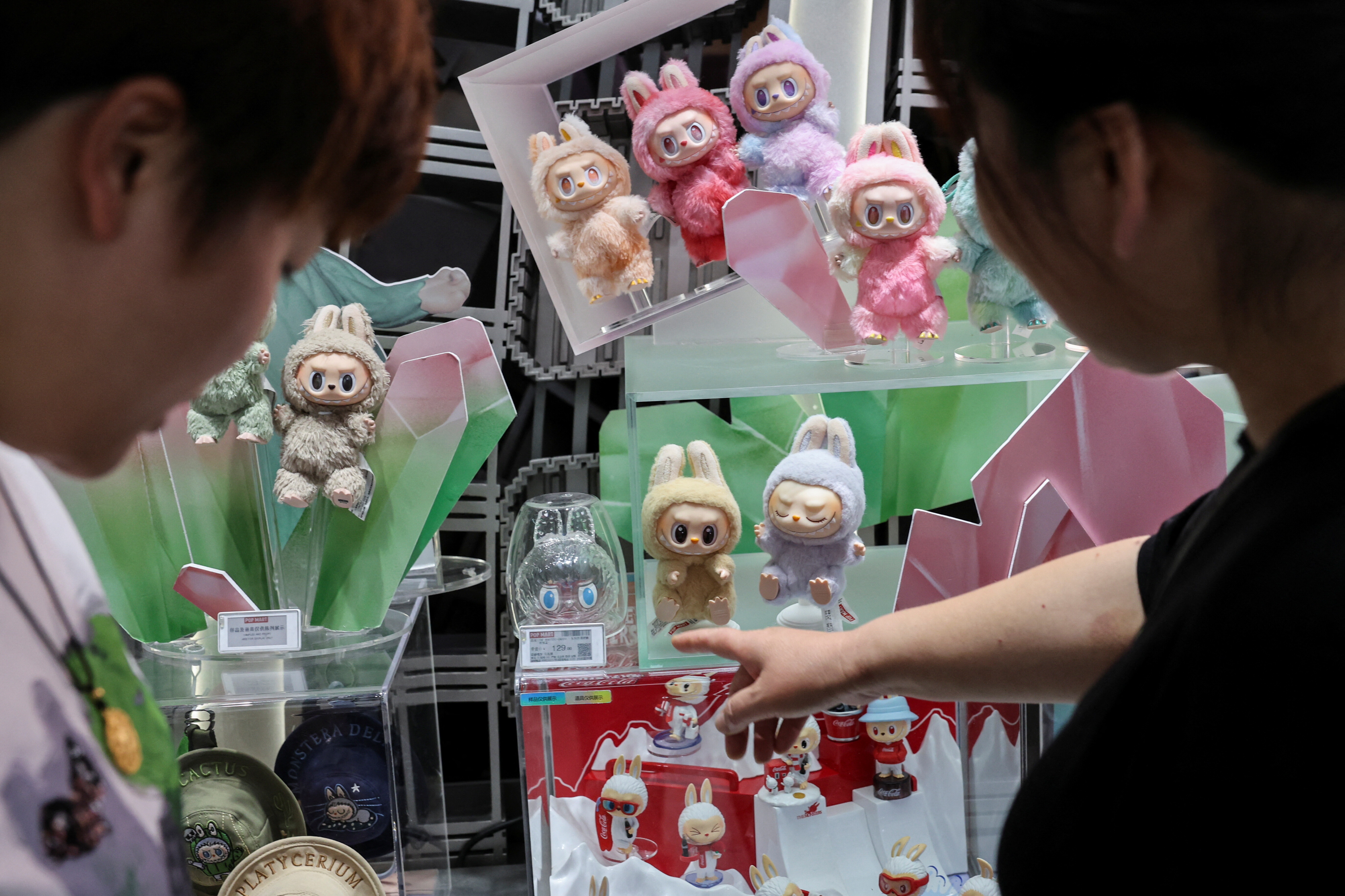 People look at Labubu dolls at the flagship store of Pop Mart in Shanghai, China June 13, 2025. REUTERS/Go Nakamura