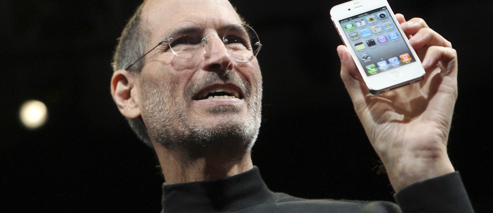 Apple CEO Steve Jobs poses with the new iPhone 4 during the Apple Worldwide Developers Conference in San Francisco, California, June 7, 2010