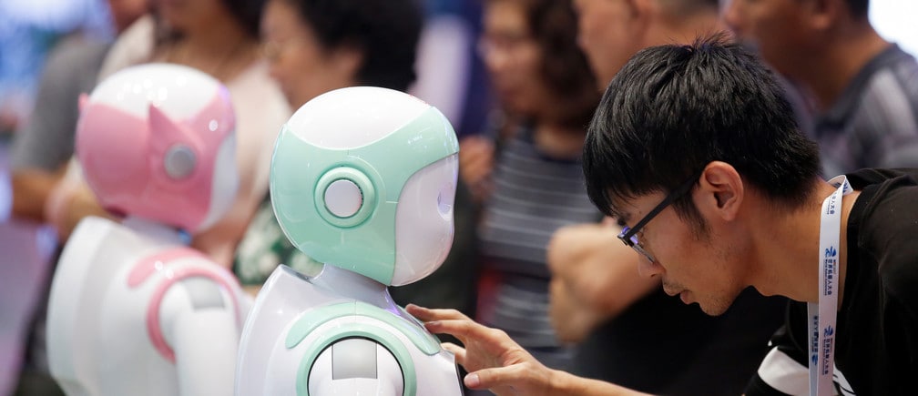 A man programs an iPal Companion Robot by Nanjing Avatar Mind Robot Technology at the 2017 World Robot conference in Beijing, China August 22, 2017. 