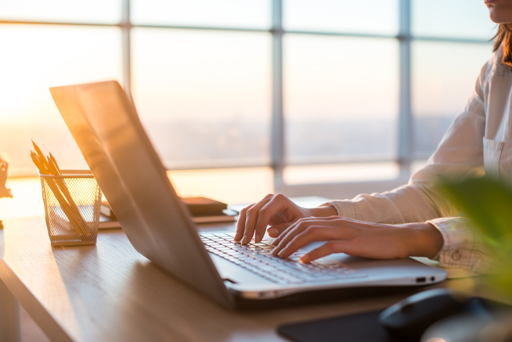 Female teleworker texting using laptop and internet, working online: Embedding AI literacy is a collective task
