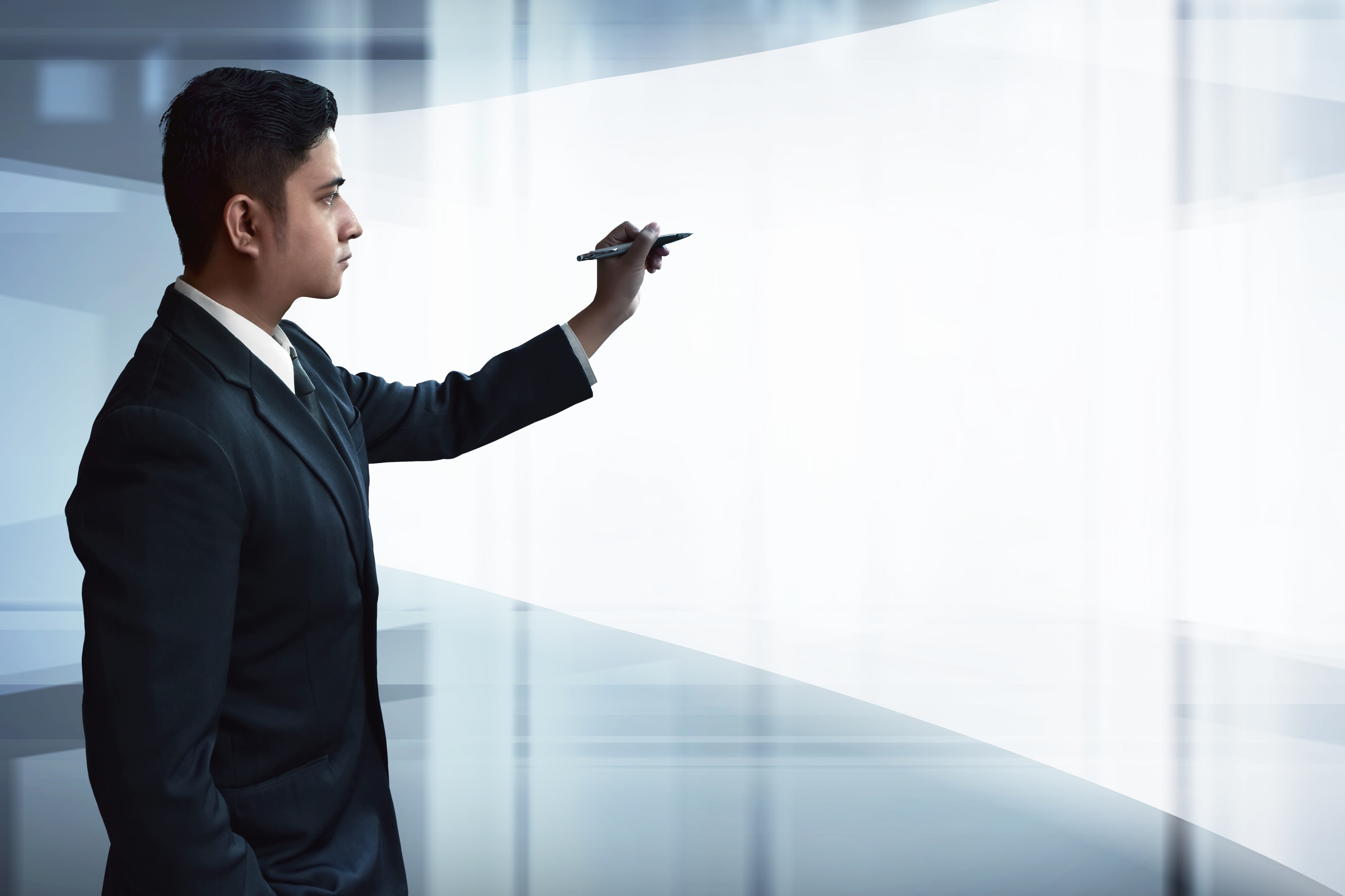 Businessman drawing on virtual screen: Thriving in the Intelligent Age means embracing paradoxes