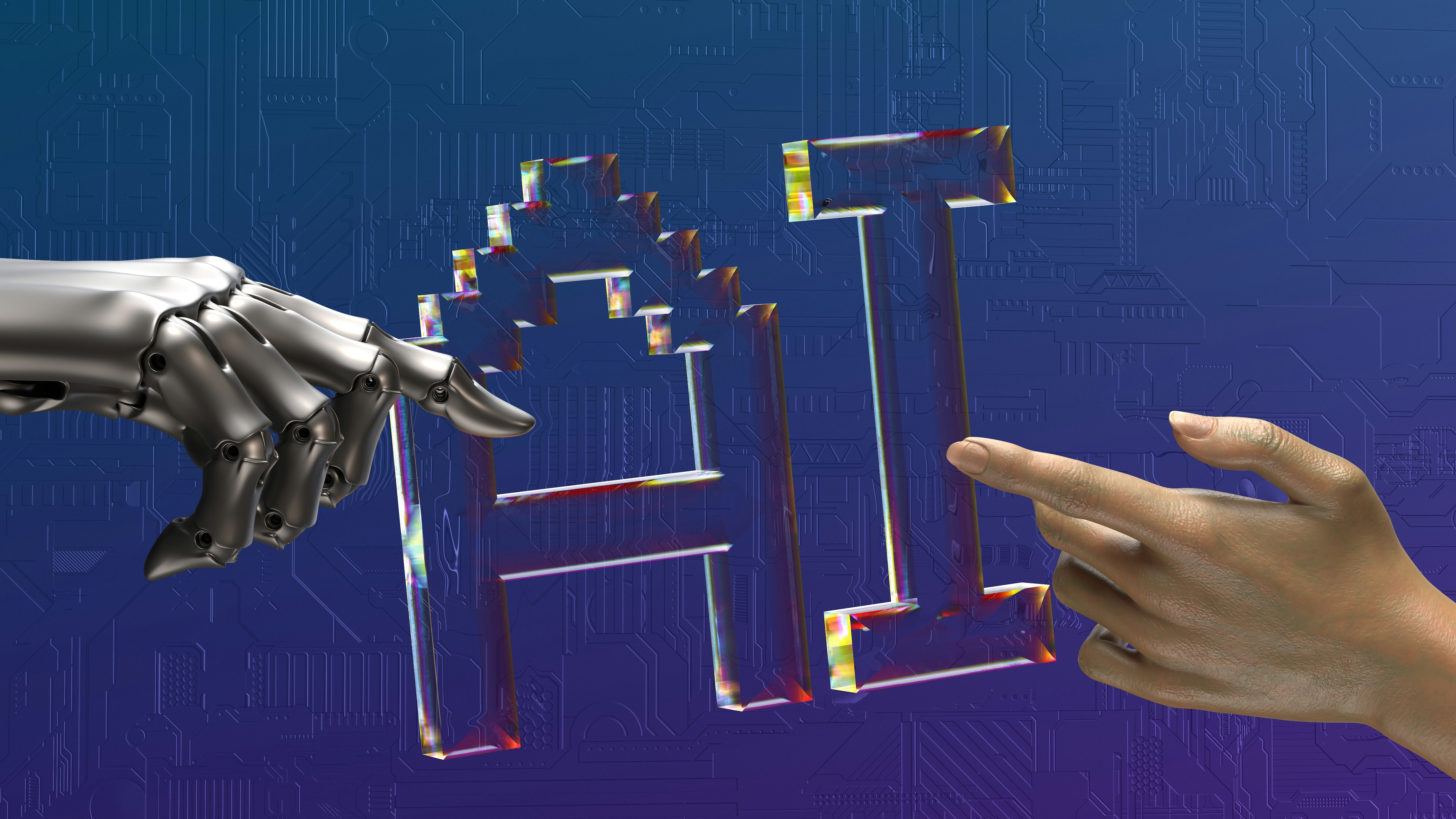 A robot hand and a human hand point towards computer-generated text that reads "AI".