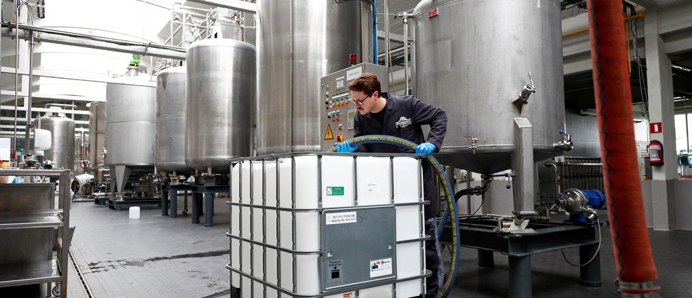 A worker is seen at a Belgian distillery that switches its production from gin to disinfecting alcohol during the coronavirus lockdown, imposed by the Belgian government in an attempt to slow down the spread of COVID-19, in Wichelen, Belgium, March 20, 2020. REUTERS/Francois Lenoir - RC2NNF9EYJ9O