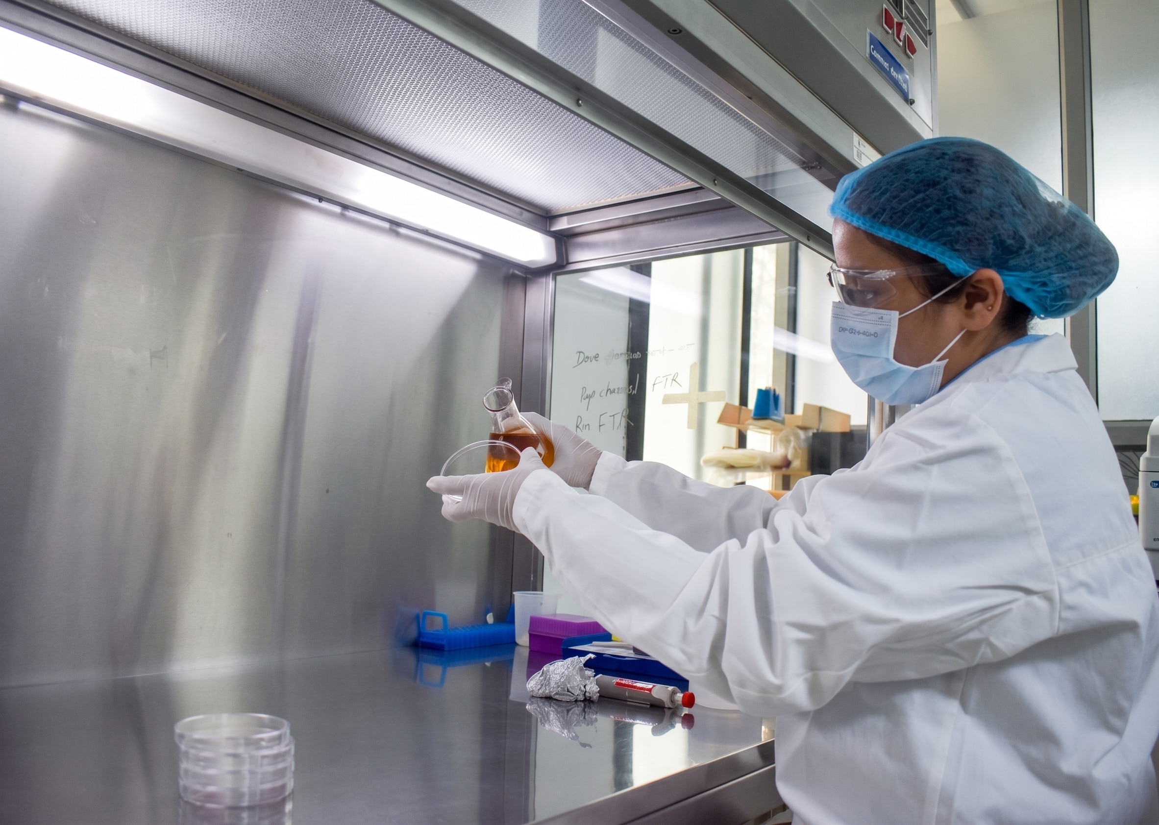 A woman works in a nail varnish factory.