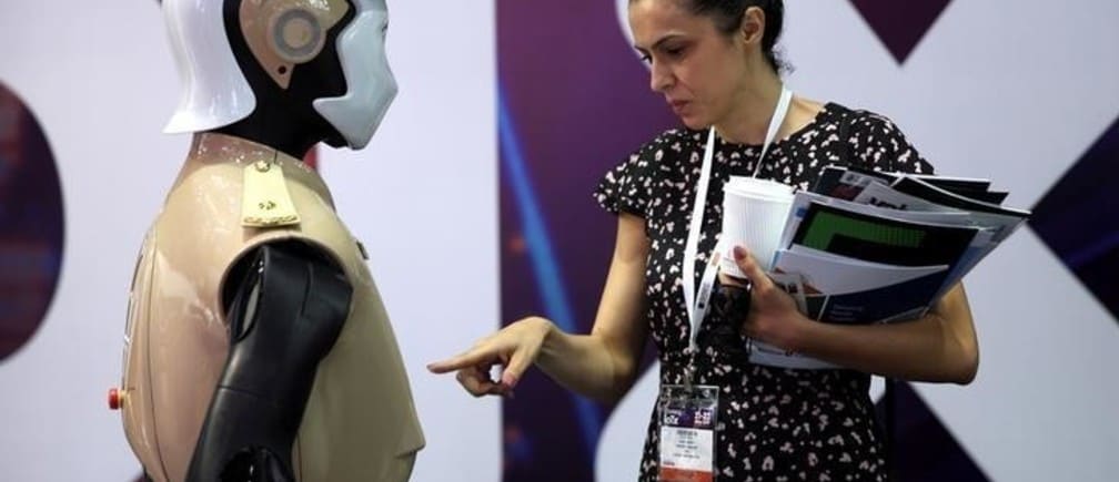 A visitor looks at an operational robot policeman at the opening of the 4th Gulf Information Security Expo and Conference (GISEC) in Dubai, United Arab Emirates, May 22, 2017. REUTERS/Stringer