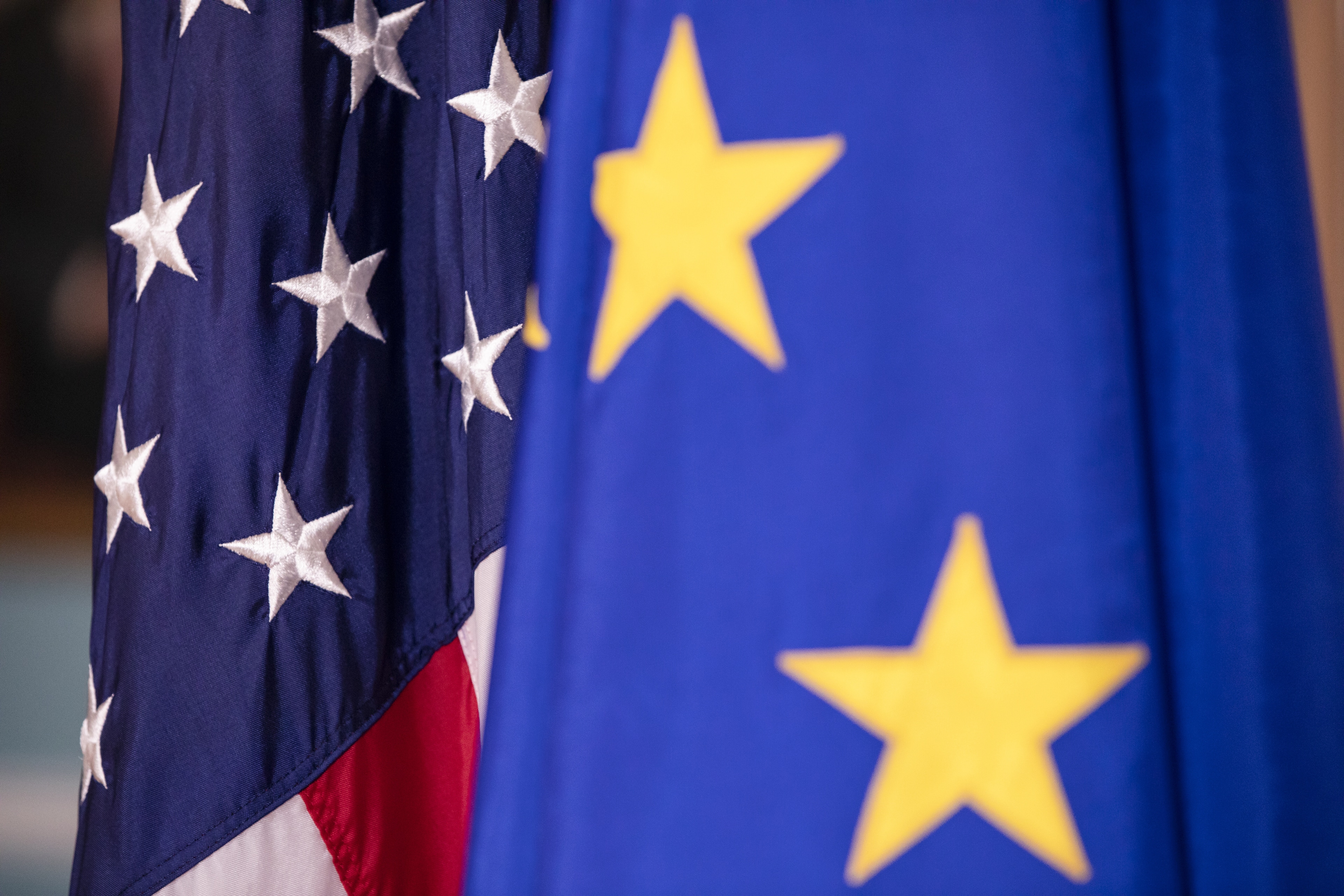 European Union and United States flags on display.