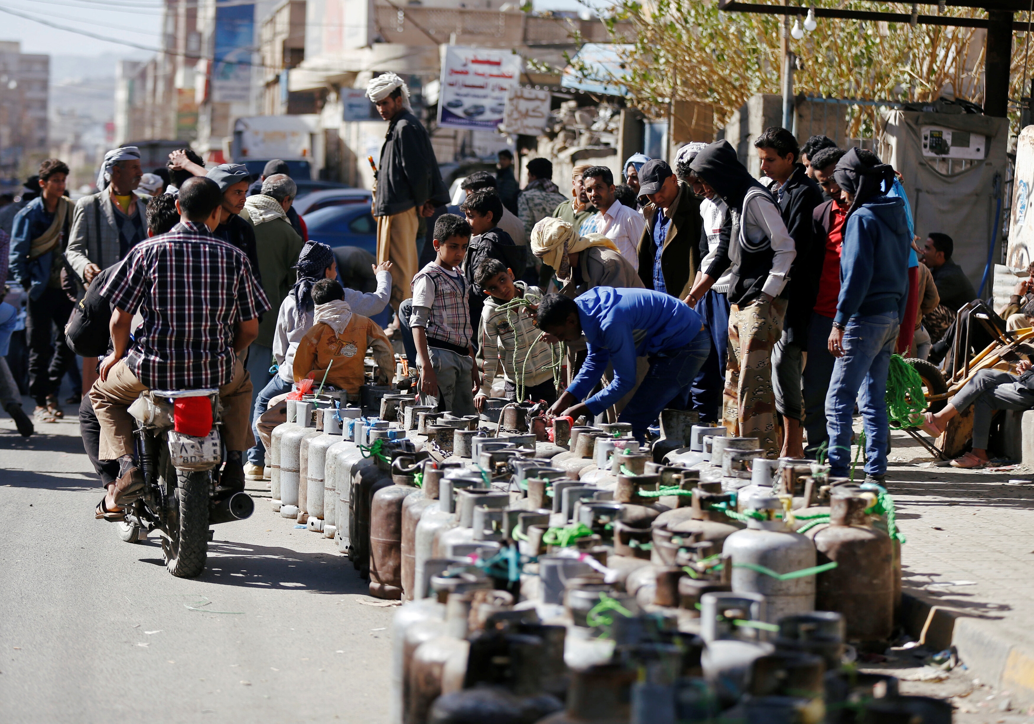 People wait to fill their cooking gas cylinders in Sanaa, Yemen.