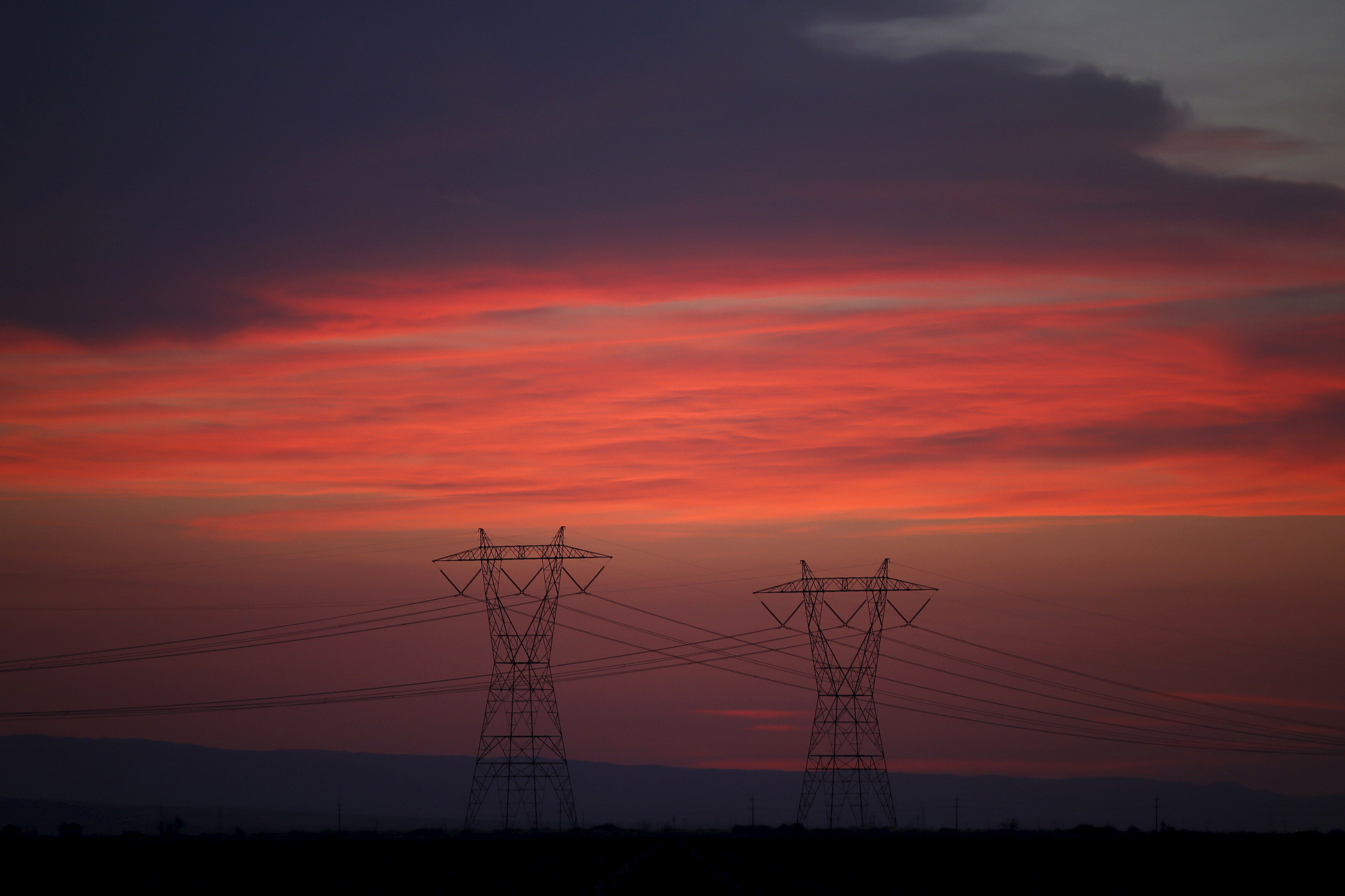 Power lines are seen at sunset near Lost Hills, California April 20, 2015: Utility resilience is a must if businesses want to stay operational amid a changing climate