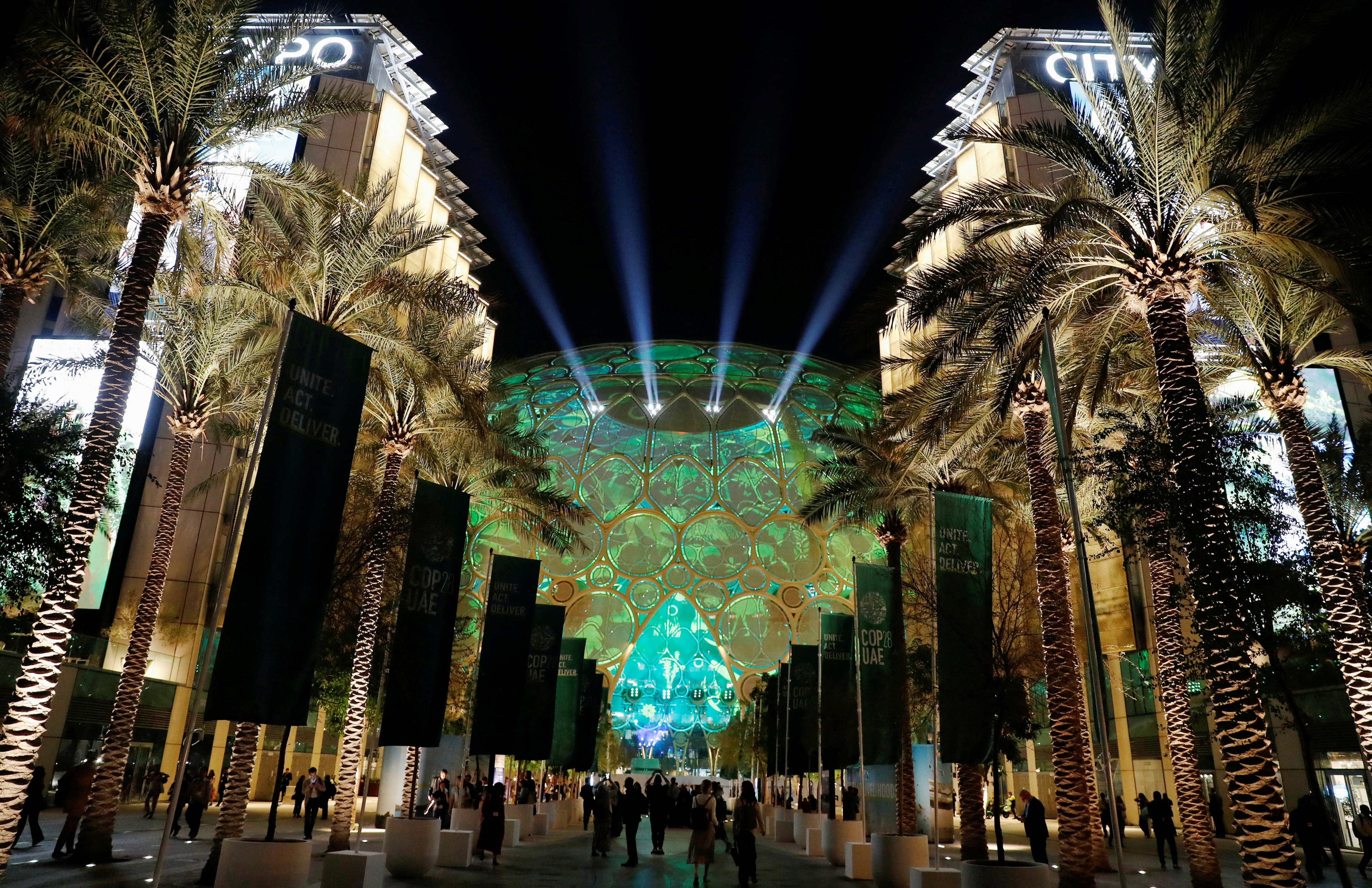 Delegates walk at Dubai's Expo City during the United Nations Climate Change Conference (COP28) in Dubai, United Arab Emirates, December 6, 2023
