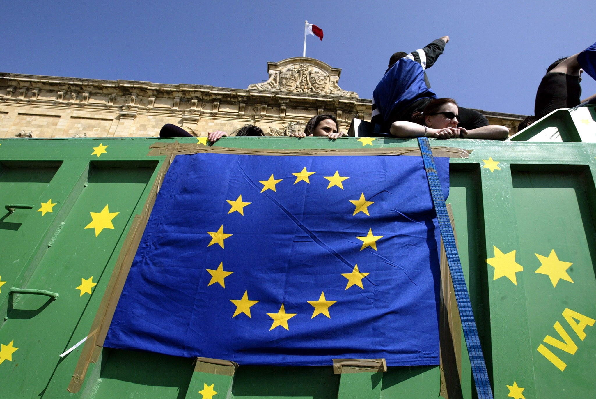 A truck with a European Union flag and the word "Iva" (meaning 'Yes') on it is driven past the office of [Malta's Prime Minister Eddie Fenech Adami] in Valletta March 10, 2003. Fenech announced that national elections would take place on April 12, and if re-elected will sign the EU Accession Treaty in Athens on April 16.?? OUT