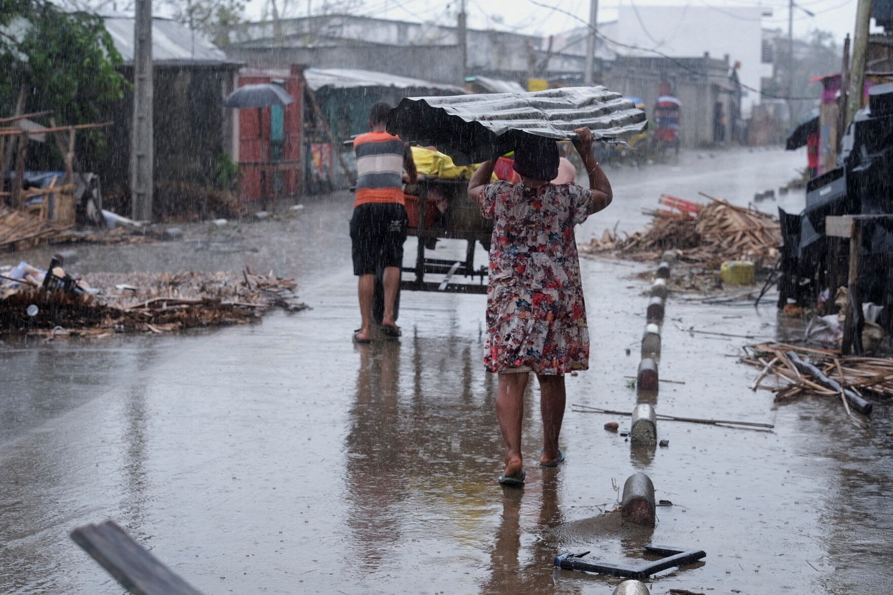 A family moves with their belongings after Cyclone Gezani tore through the port city of Toamasina, on the island of Madagascar, Africa.