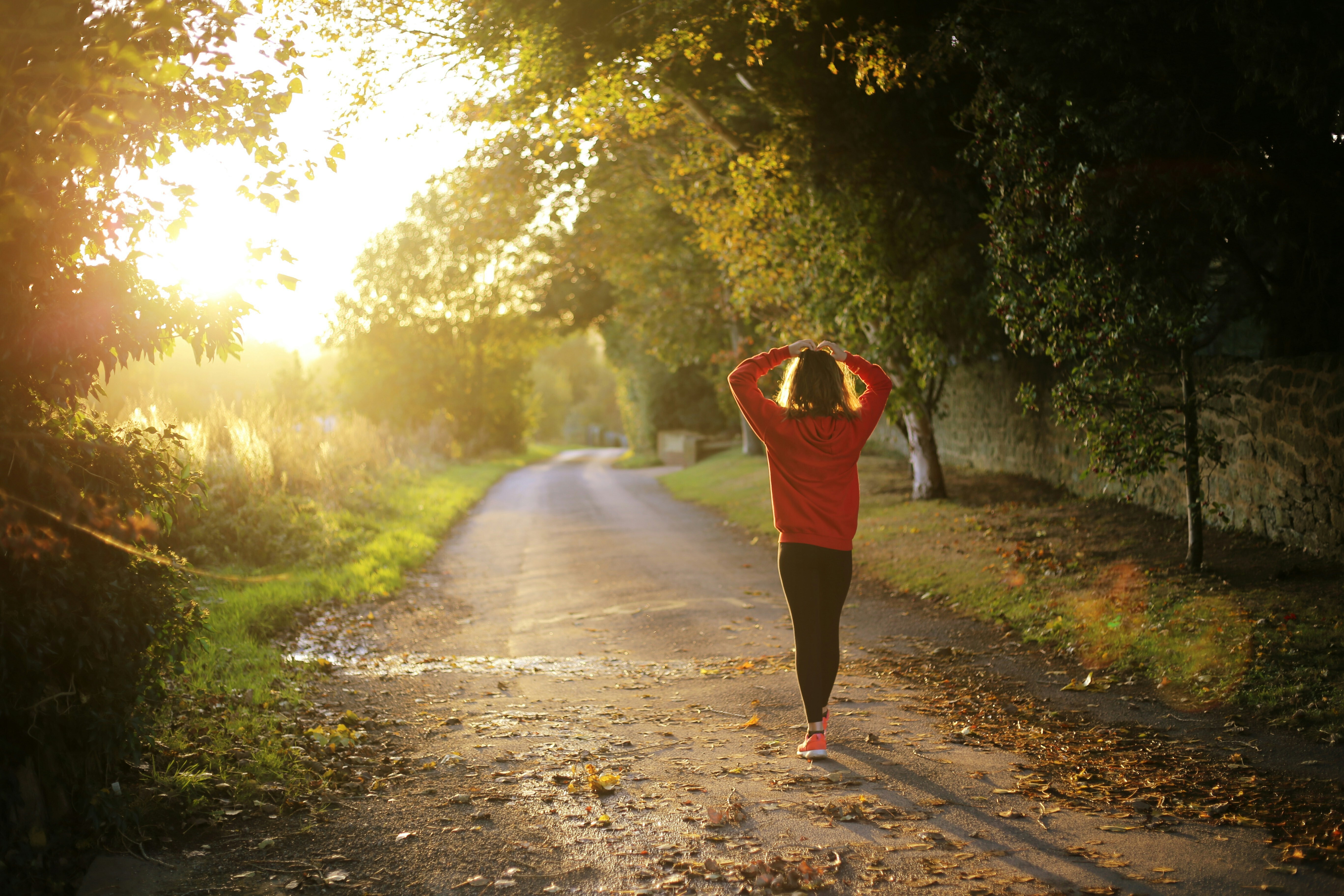Woman walking at sunrise.