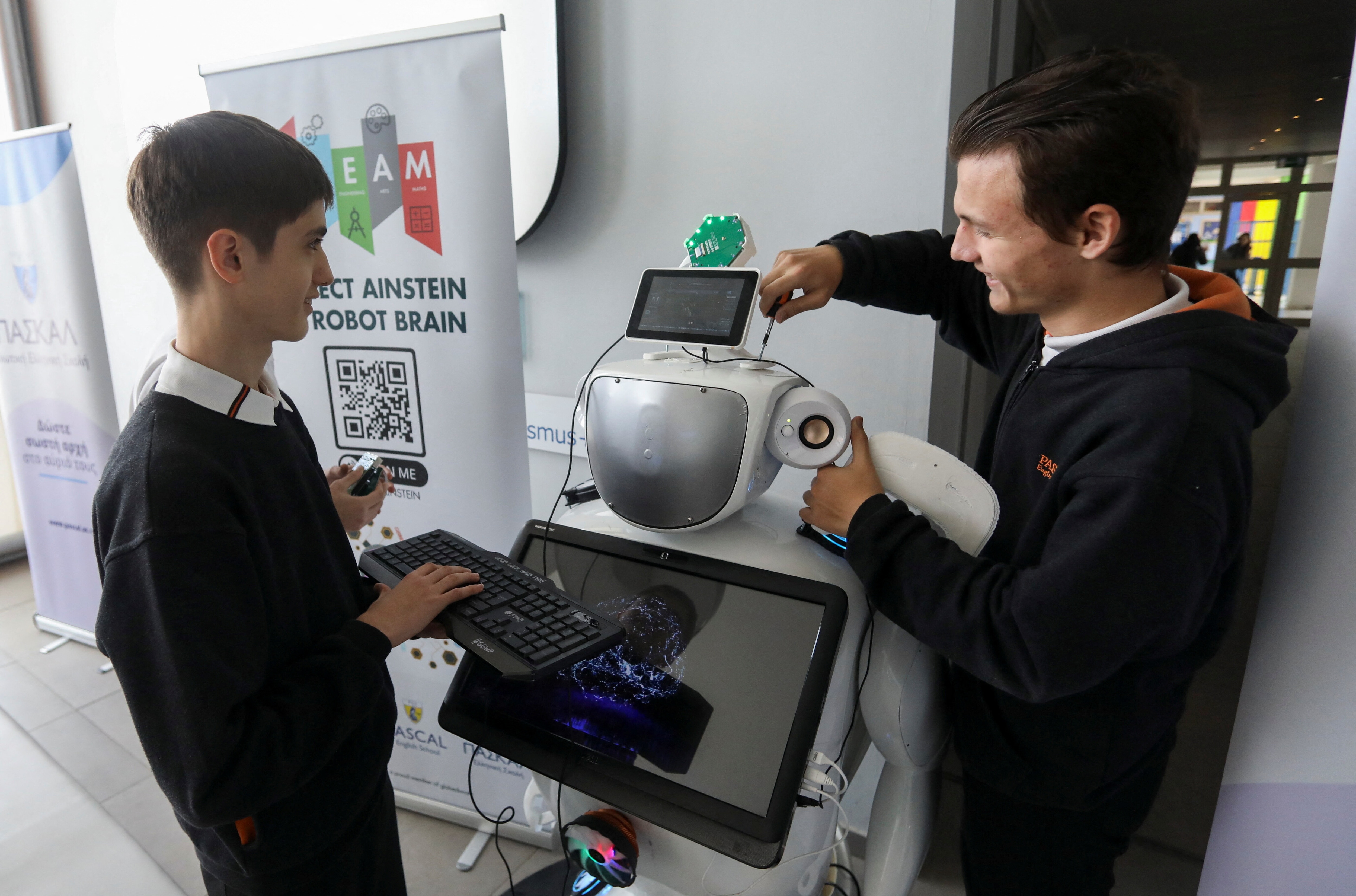 High school students Richard Erkhov and Vladimir Baranov work on "Alnstein", a robot powered with ChatGPT, in Pascal school in Nicosia, Cyprus, March 30, 2023: AI can free up time for us to work on human connection
