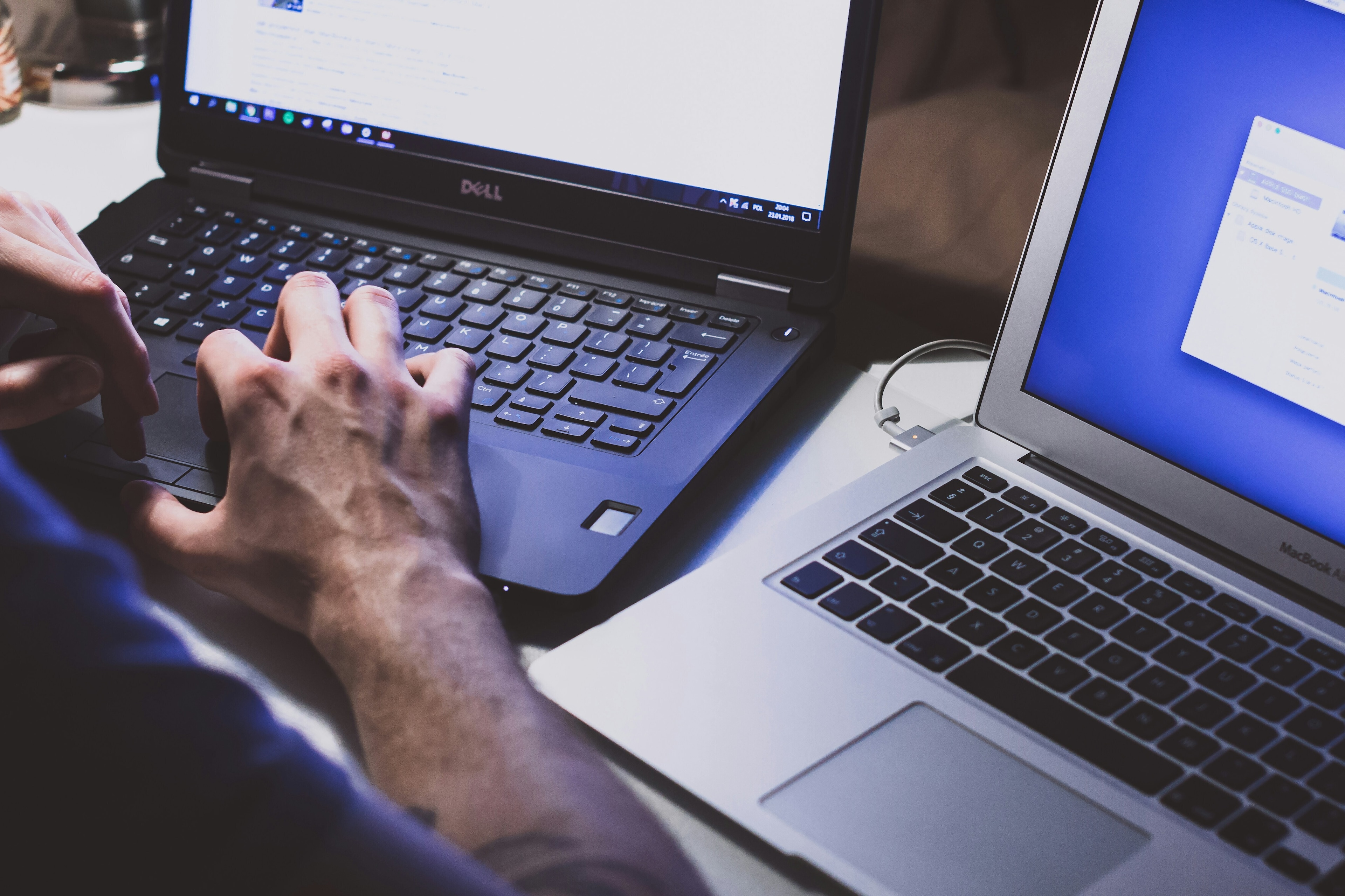 Cybersecurity: a person in close-up at their laptop.