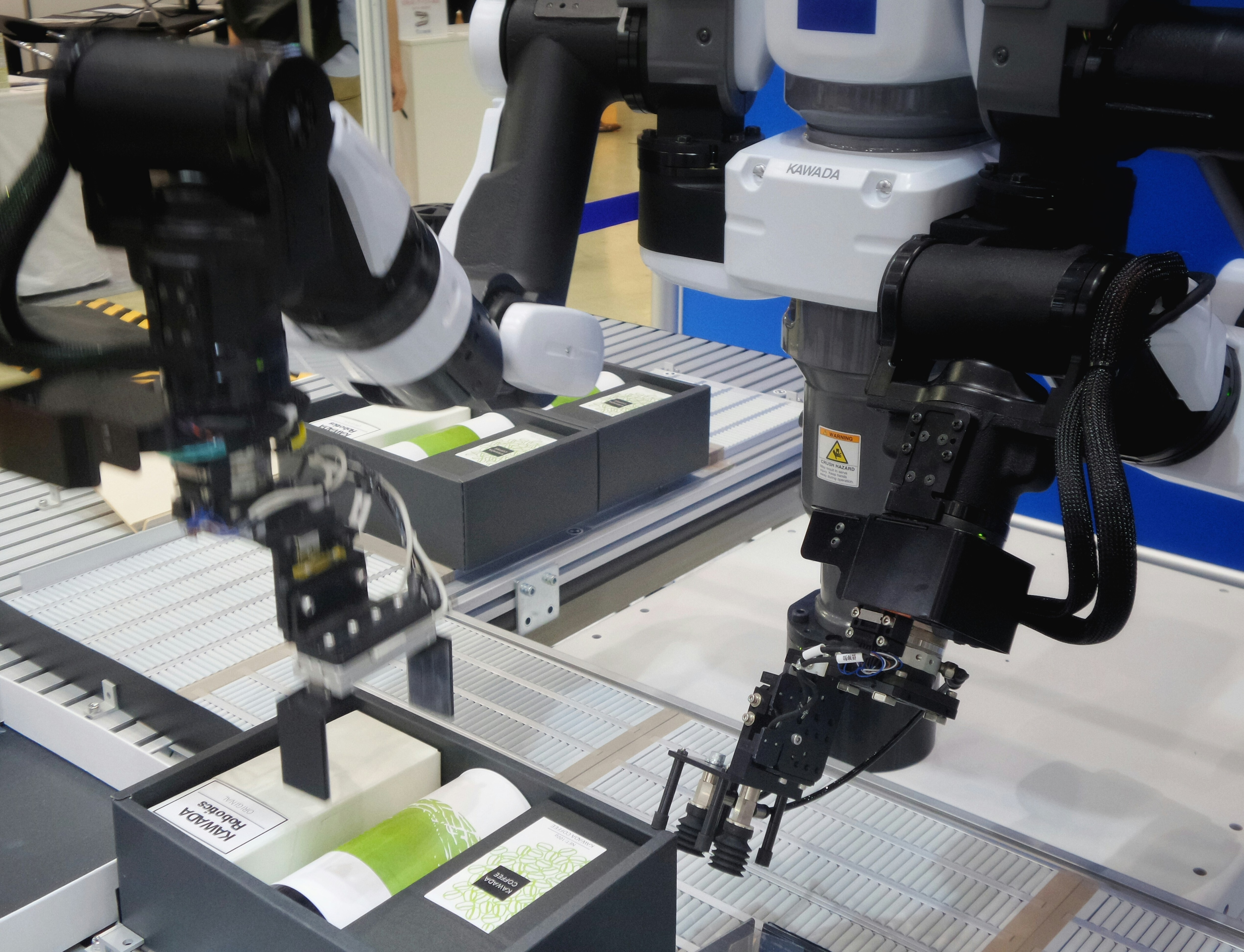 A set of robots is seen working in a factory.