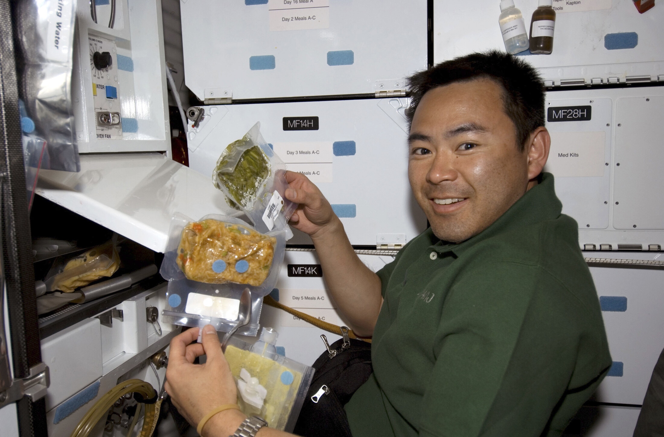 Aerospace Exploration Agency (JAXA) astronaut Akihiko Hoshide prepares to eat a meal at the galley on the middeck of Space Shuttle Discovery in this photo released by NASA  June 3, 2008: Space food remains one of the most critical constraints on long flights to the Moon