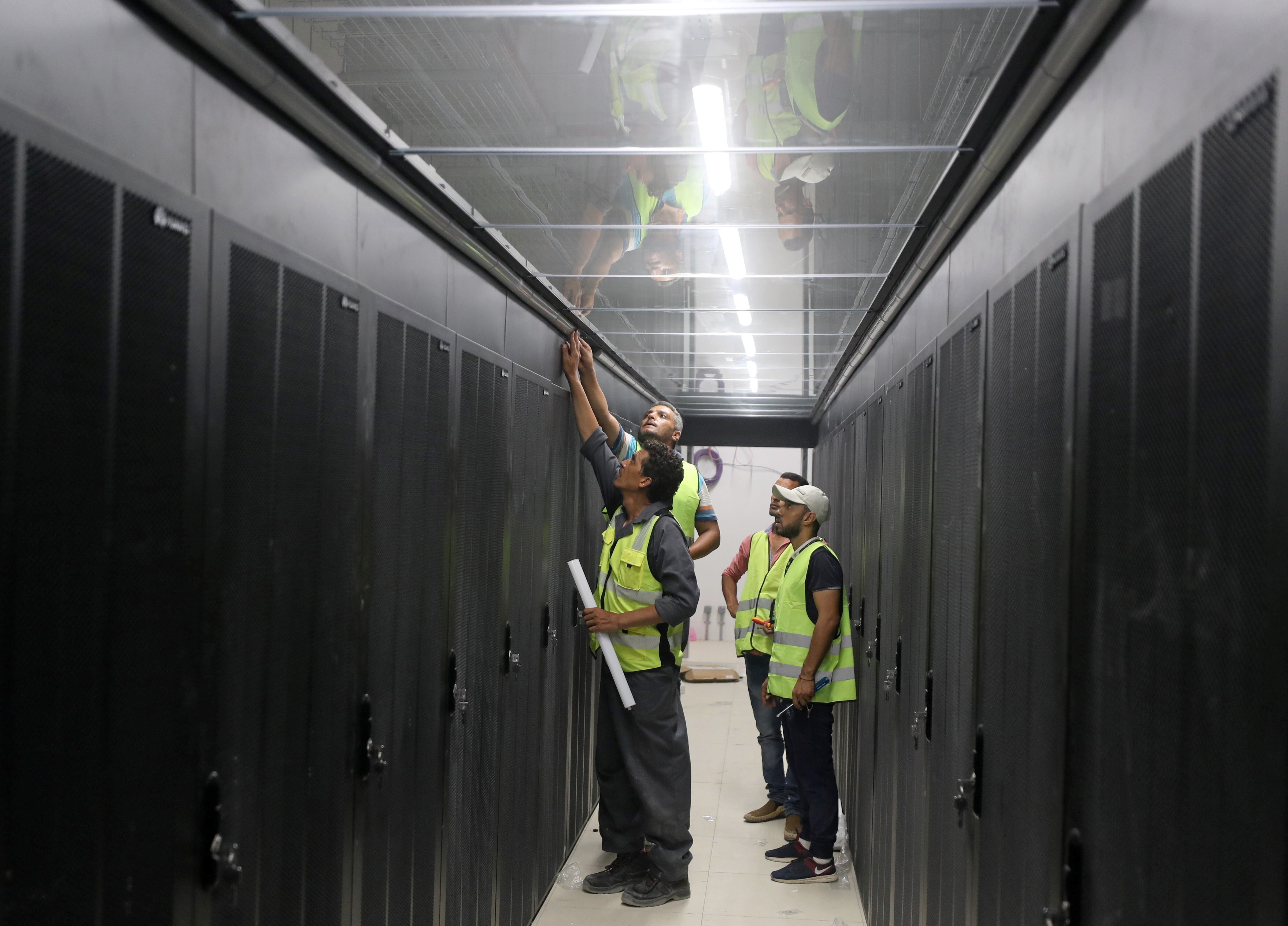 Engineers install server cabinets at an under construction data center in the New Administrative Capital (NAC) east of Cairo, Egypt July 5, 2021. Picture taken July 5, 2021. REUTERS/Mohamed Abd El Ghany