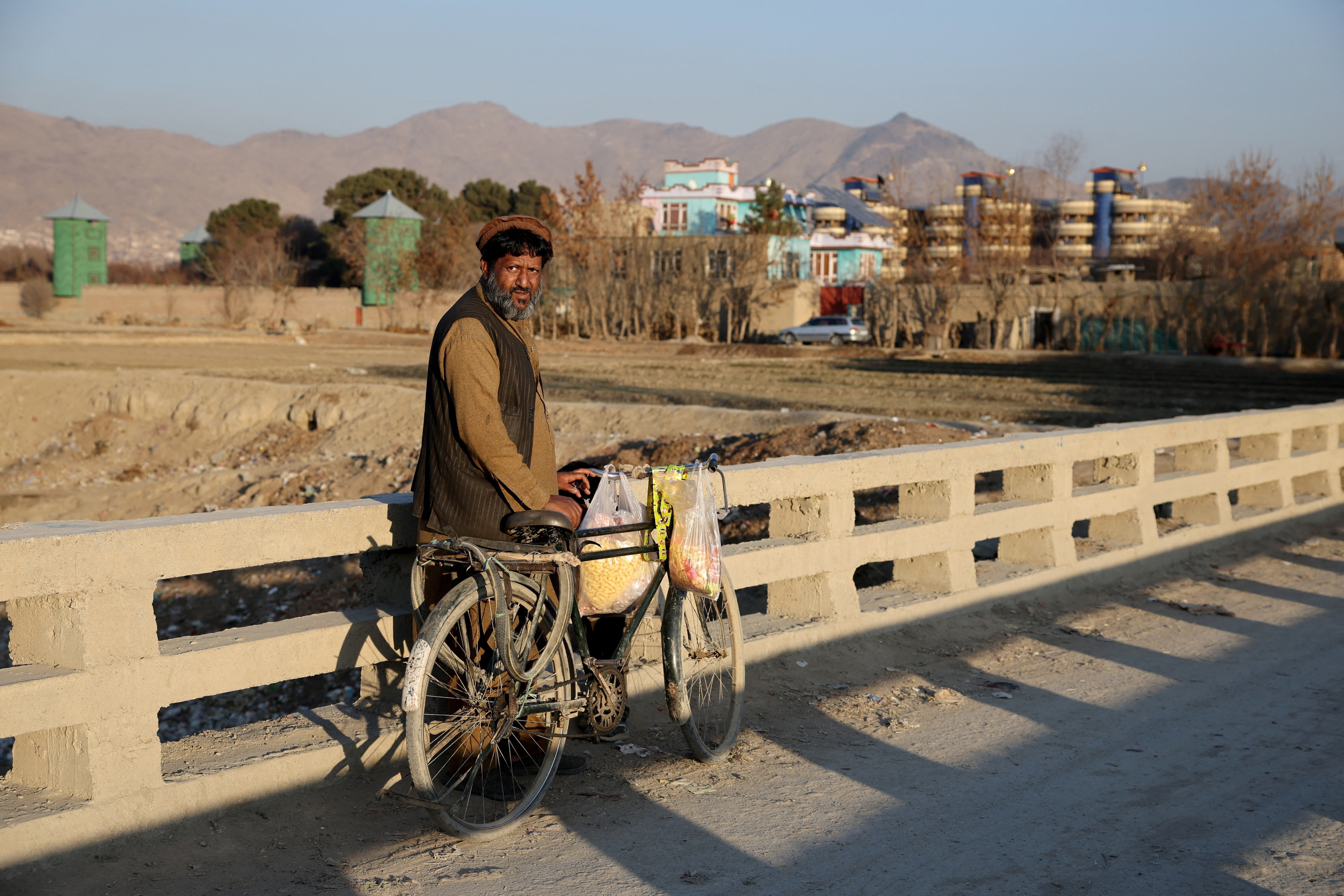 Samiullah, 55, who, along with his family, was deported by neighbouring Iran, sells pugged corn on the outskirts of Kabul, Afghanistan, January 7, 2026.  REUTERS/Sayed Hassib