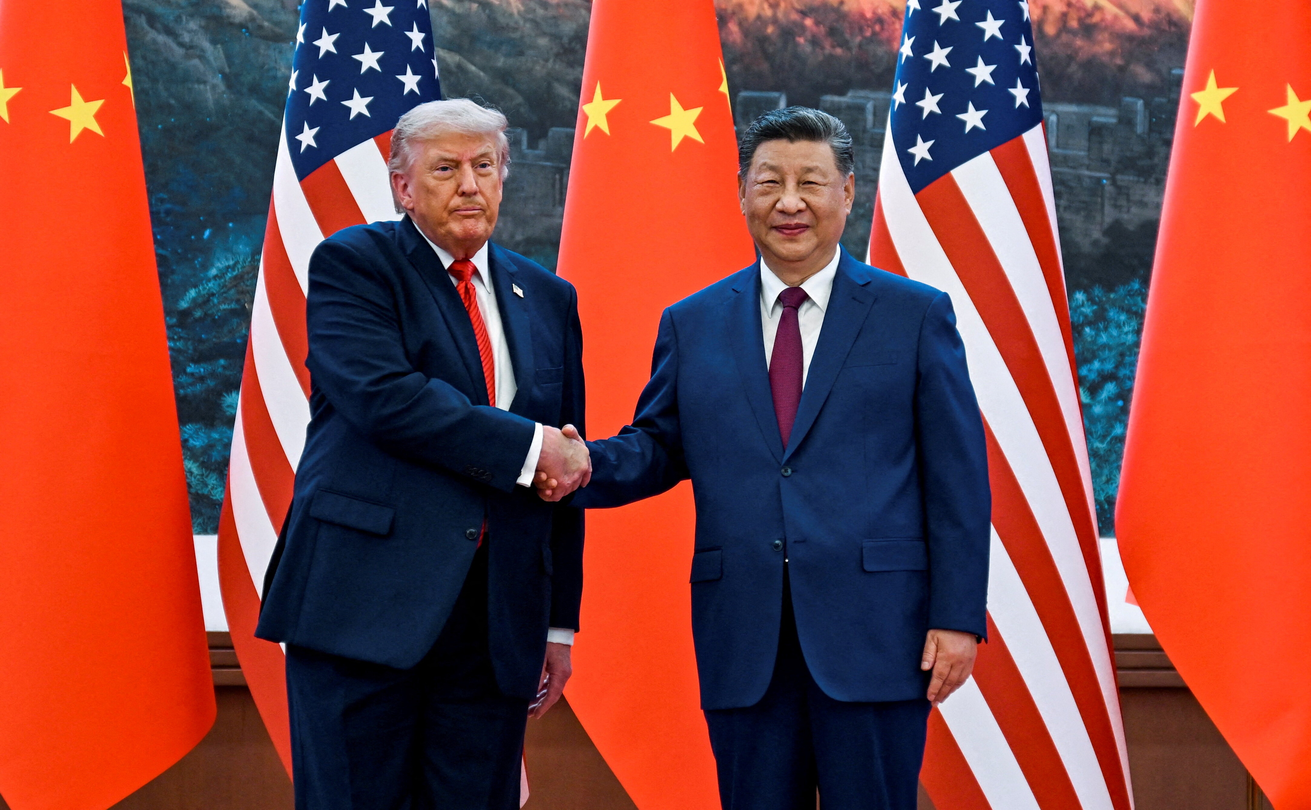 US President Donald Trump and Chinese President Xi Jinping shake hands at the Great Hall of the People in Beijing, China. 