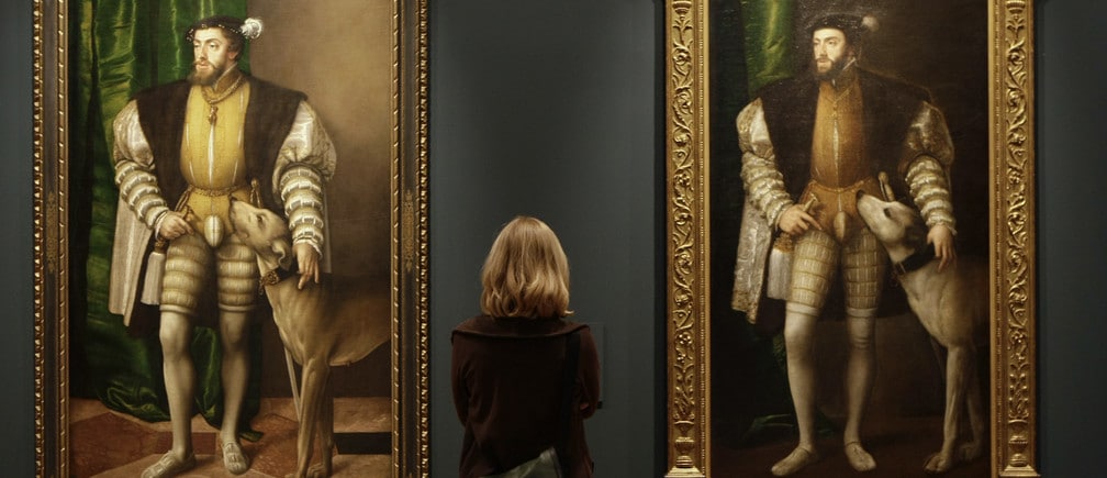 A woman looks at paintings titled "Carlos V con un perro" by Austrian artist Jacob Seisenegger during the press presentation of the "The Renaissance Portrait" exhibition at Madrid's El Prado museum May 30, 2008. REUTERS/Juan Medina (SPAIN) - GM1E45U1QQ101