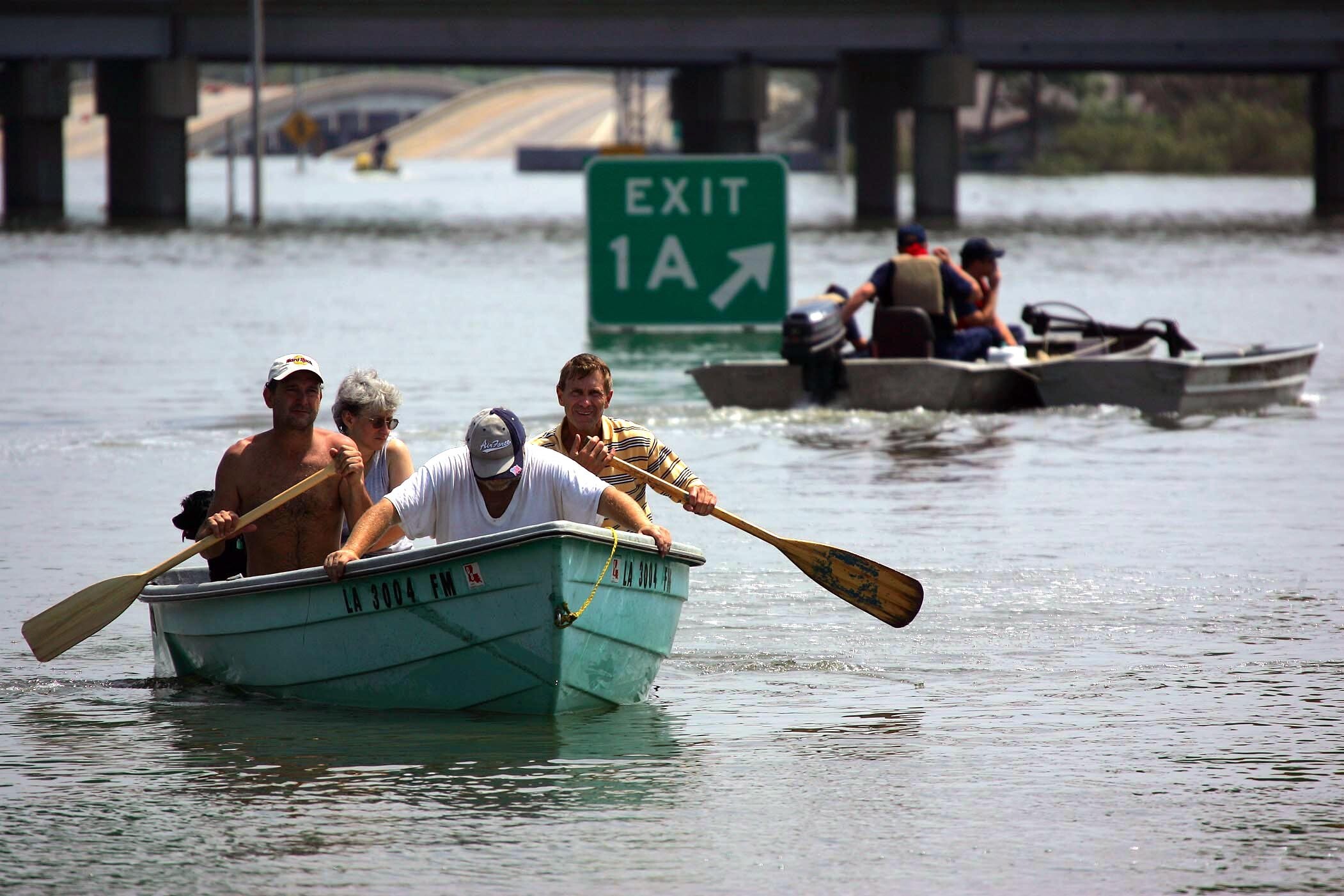 Members of the MO/TN Incident Response Teams Urban Search and Rescue teams and local officials help evacuate people trapped in their flooded homes by Hurricane Katrina, in New Orleans, Louisiana, August 30, 2005. Floodwaters engulfed much of New Orleans on Tuesday as officials feared a steep death toll and planned to evacuate thousands remaining in shelters after the historic city's defenses were breached by Hurricane Katrina. REUTERS/Vincent Laforet/Pool  TBA/PN
