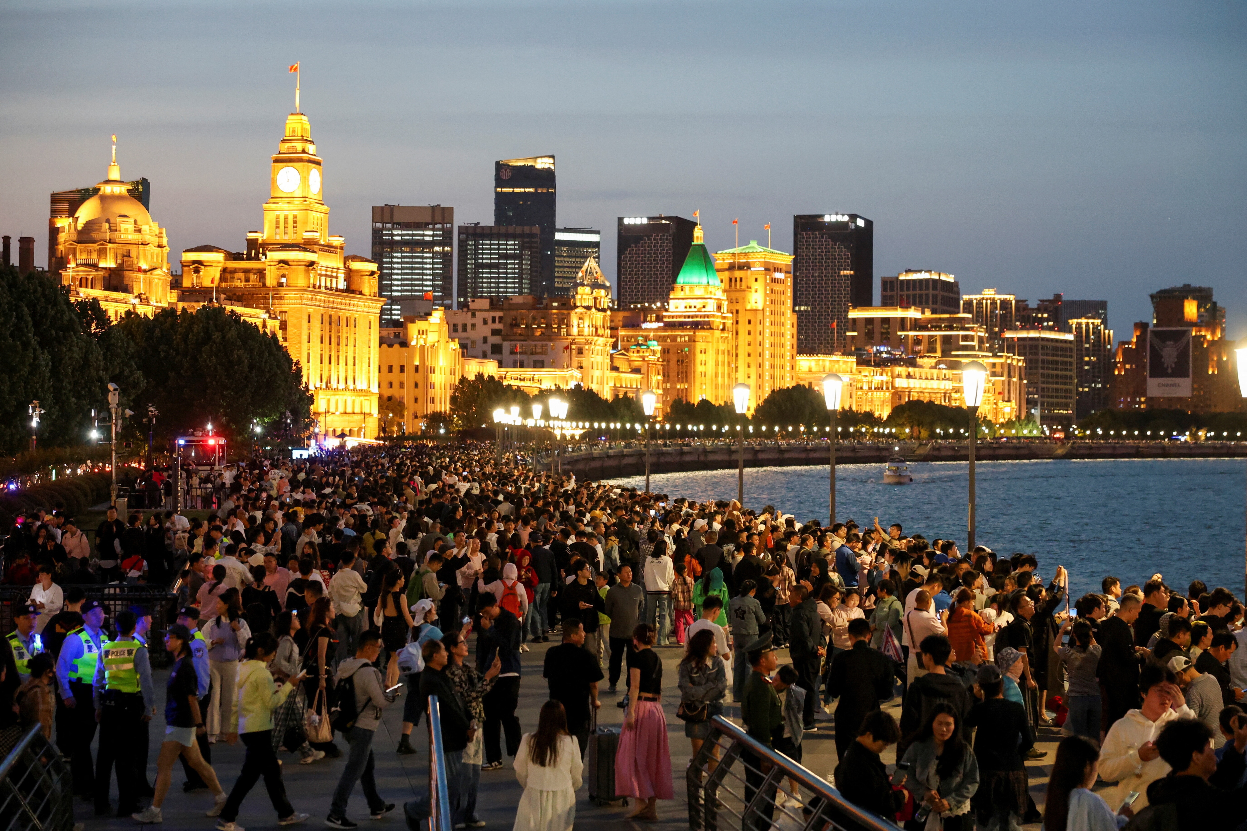 People enjoy the city lights at the Bund during the five-day Labour Day holiday in Shanghai, China May 4, 2025.