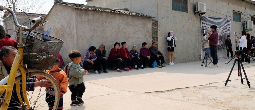 Workers from a Chinese data company take photos of the villagers for a facial recognition project.