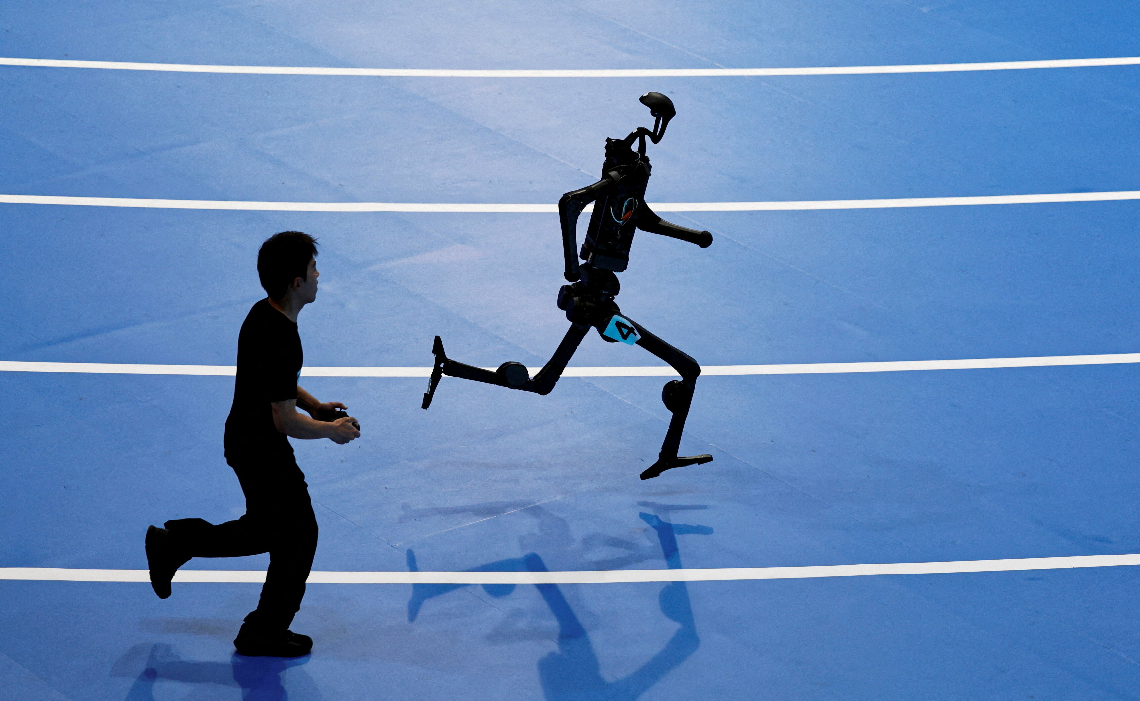 A Unitree Robotics humanoid robot takes part in a 400m race at the inaugural World Humanoid Robot Games, at the National Speed Skating Oval in Beijing, China.